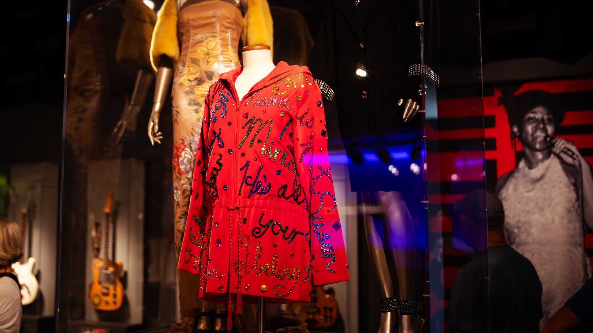 A sparkling red jacket with letters on it. 