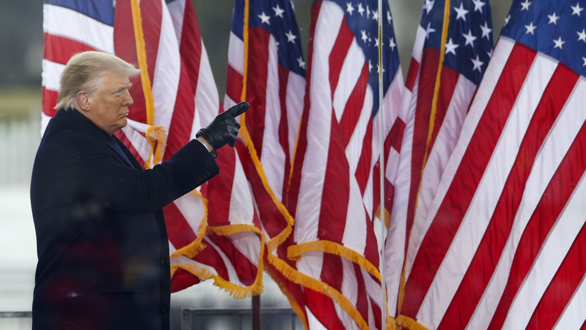 Photo of Donald Trump raising a finger as he looks into the distance