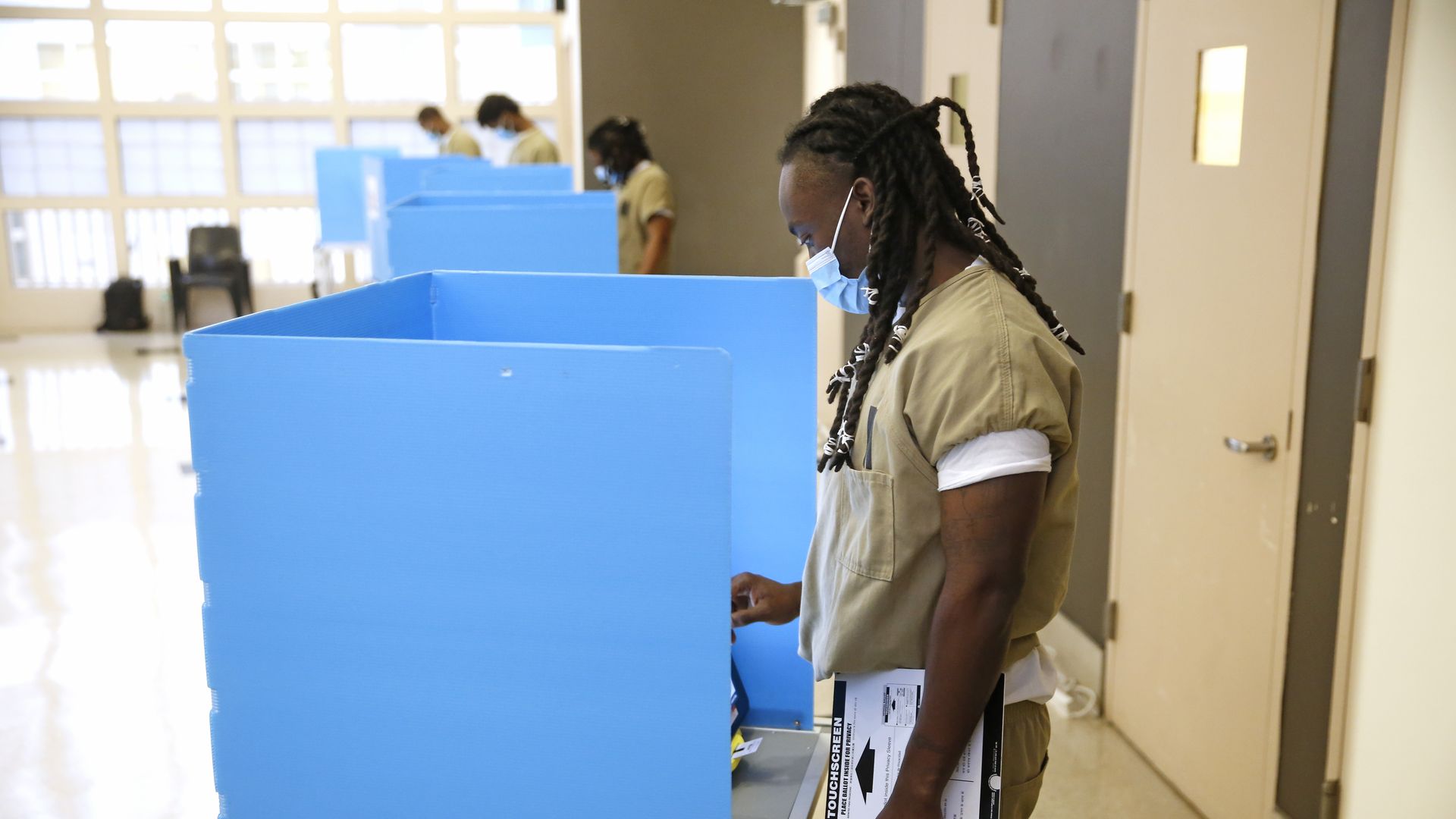 A Cook County jail detainee uses a touch screen to cast his votes at a polling place in the facility set up for early voting on October 17, 2020 in Chicago.