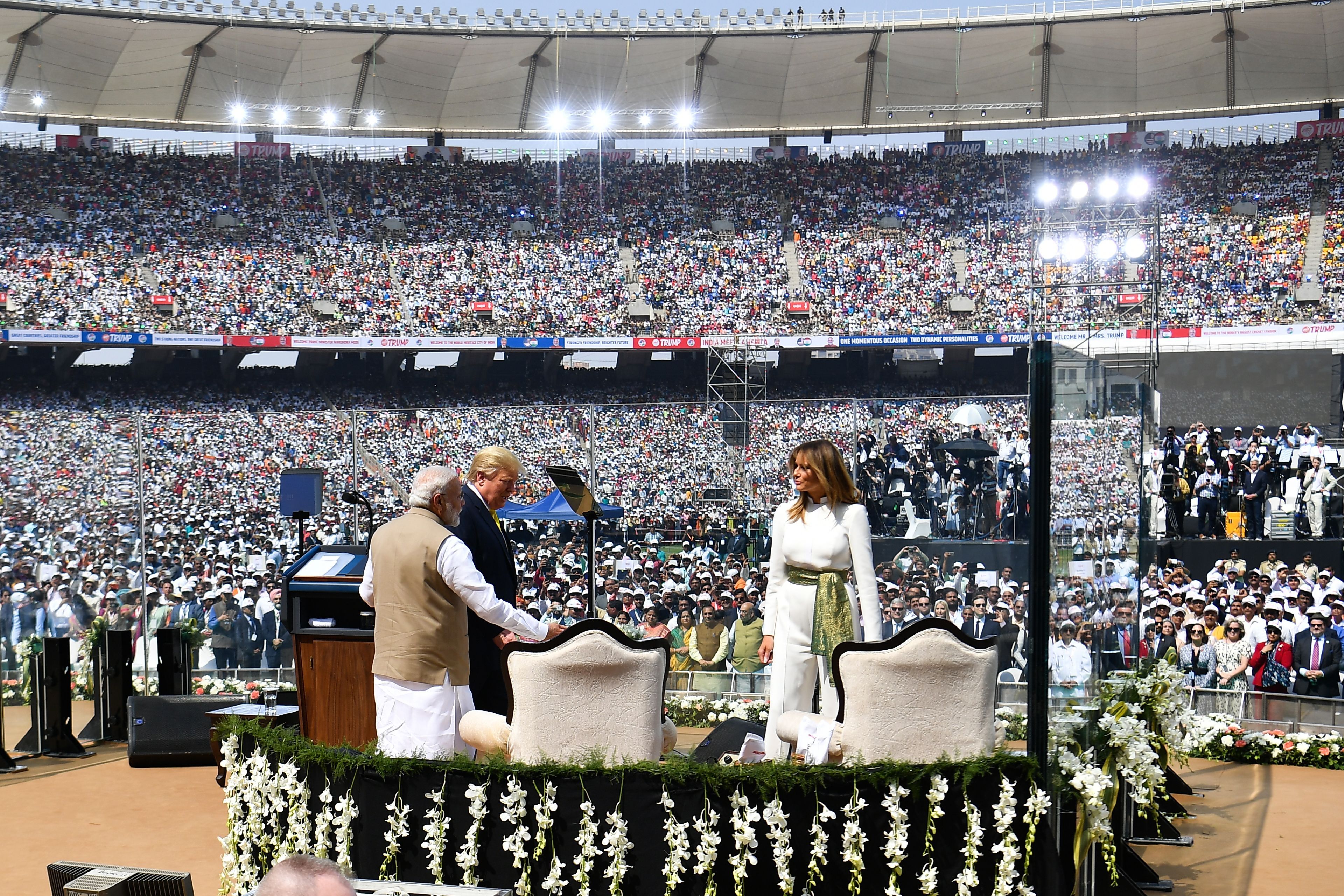 Trump (C), First Lady Melania Trump (R) and India's Prime Minister Narendra Modi arrive to attend 'Namaste Trump' rally at Sardar Patel Stadium in Motera, on the outskirts of Ahmedabad, on February 24