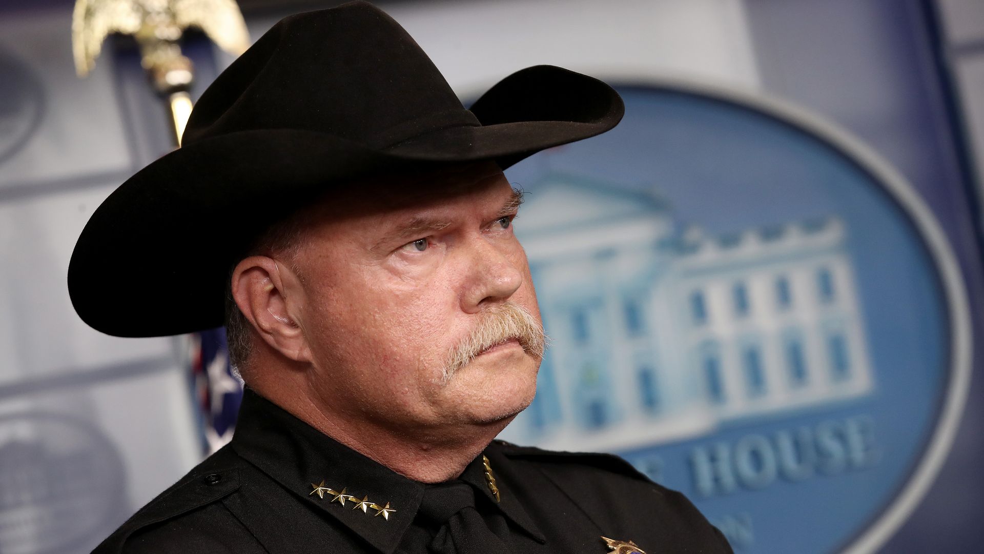 An angry sheriff in a cowboy hat