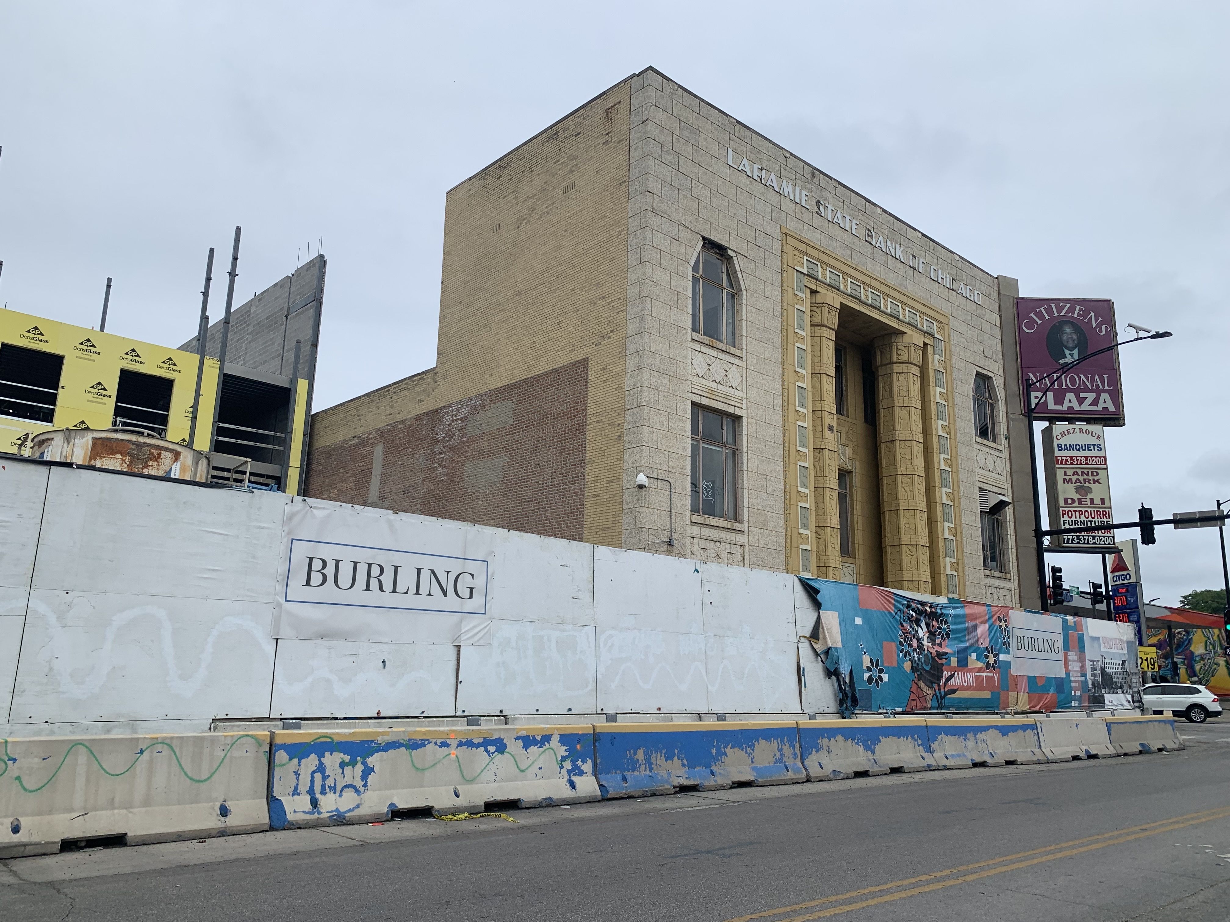 Photo of a building with blocked off construction barriers surrounding it. 