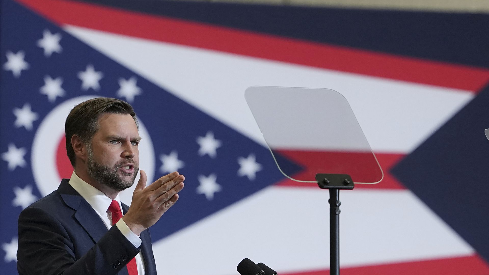 JD Vance in front of an Ohio state flag.