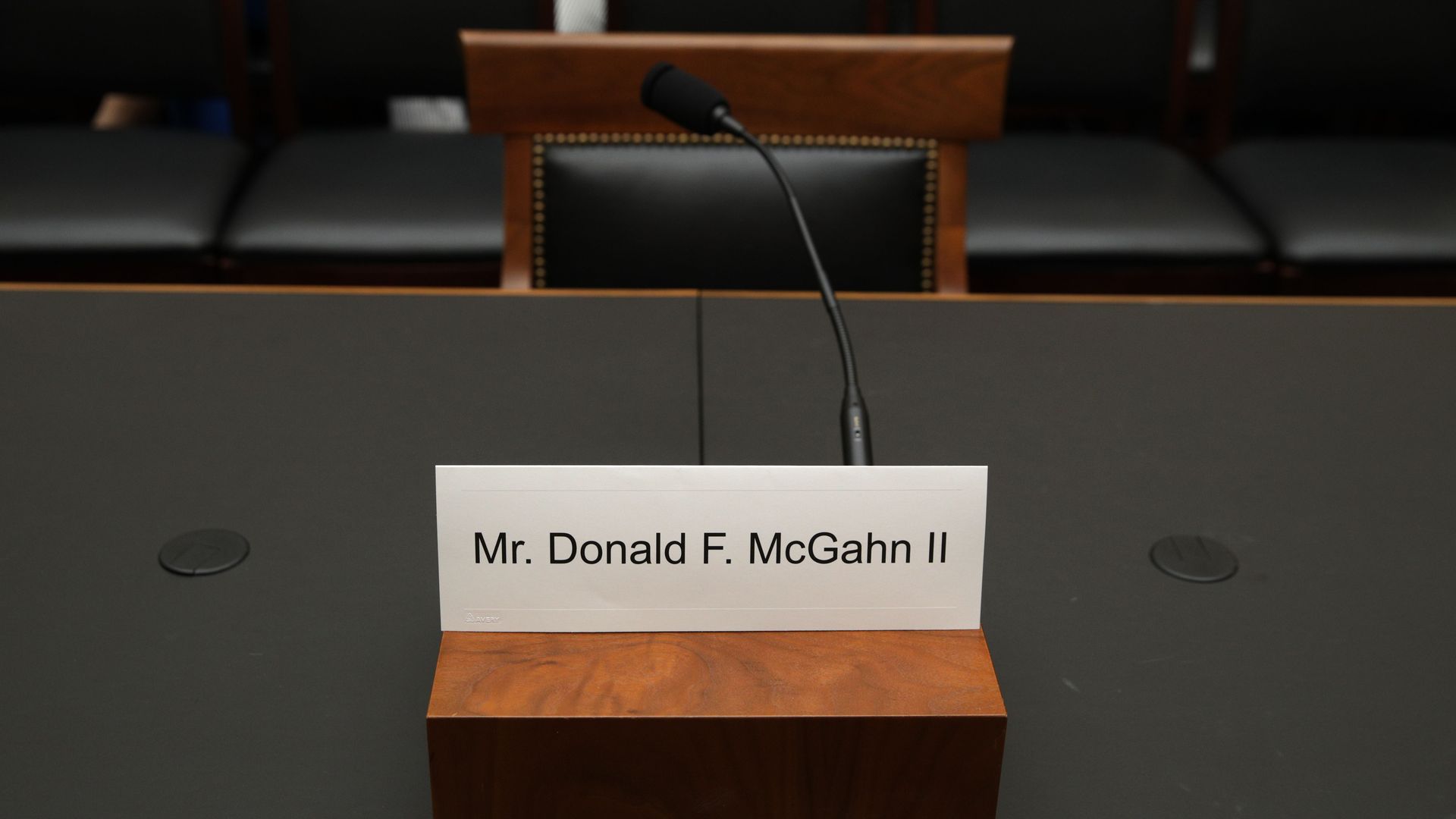 This image shows a placard for McGahn in front of an empty seat.