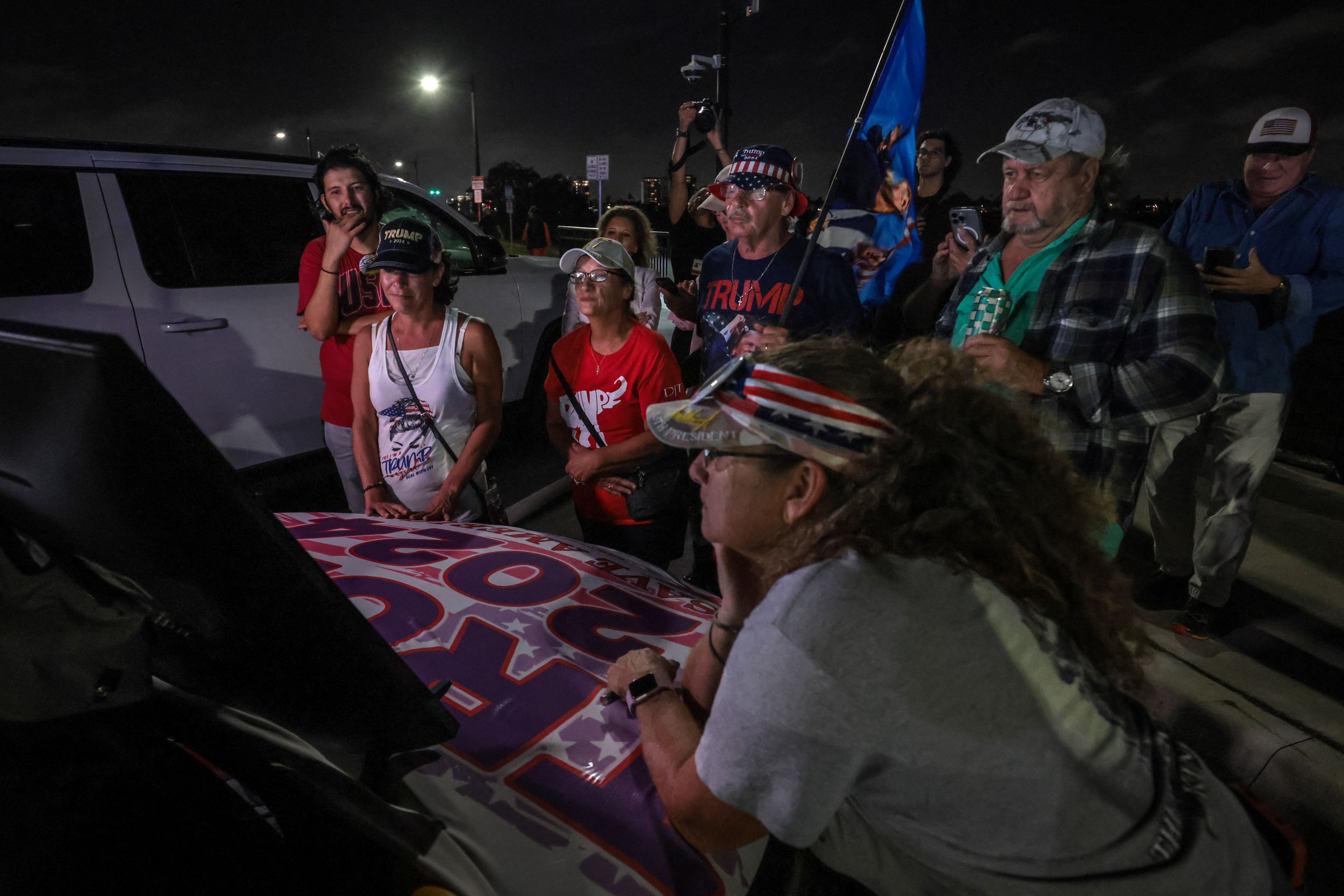 Supporters of former US president and Republican presidential candidate Donald Trump gather to follow the election results on a screen near his Mar-a-Lago resort in Palm Beach, Florida, on Election Day, November 5, 2024.