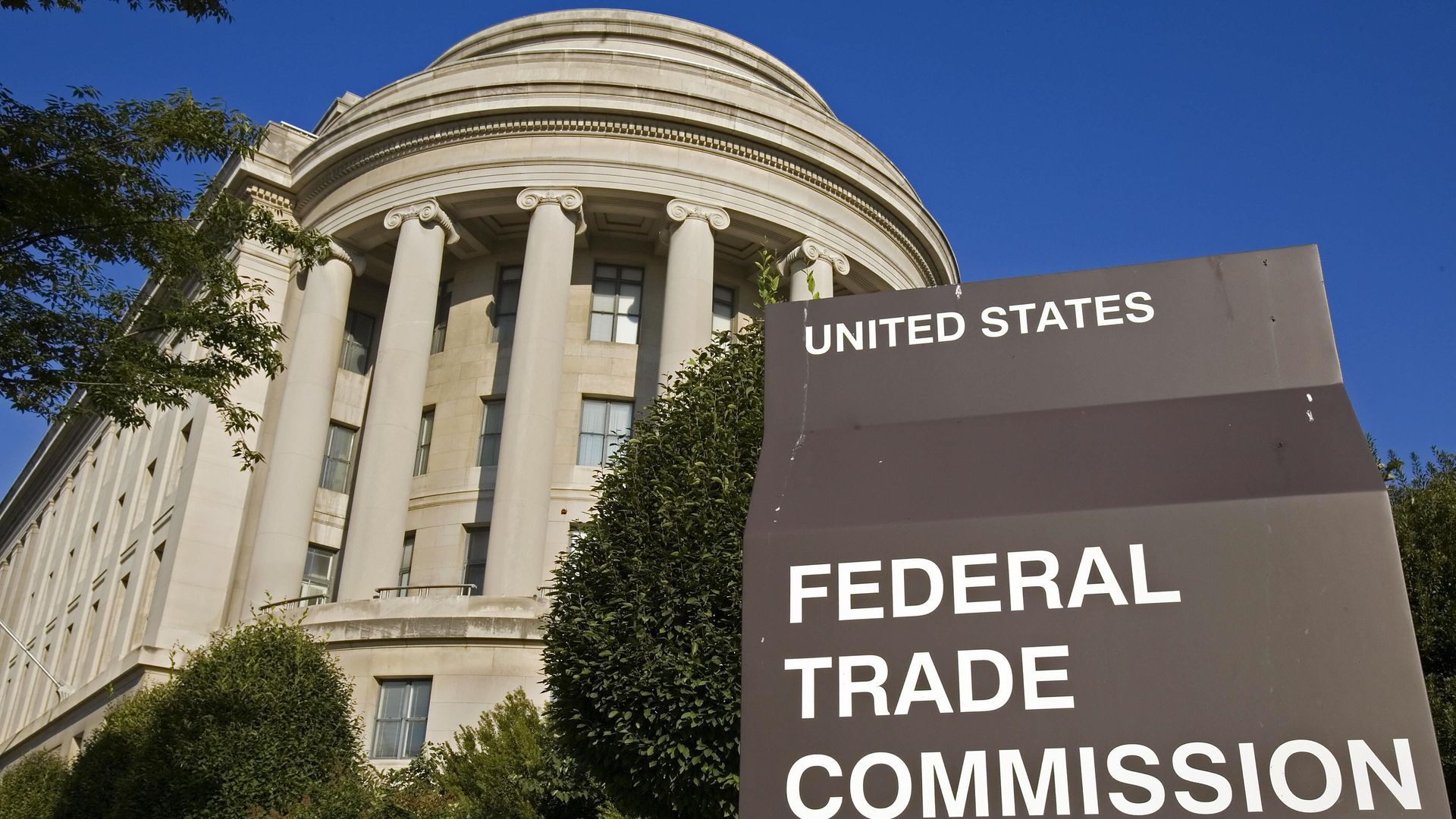 The Federal Trade Commission's building in Washington, DC, stands behind a sign for the agency