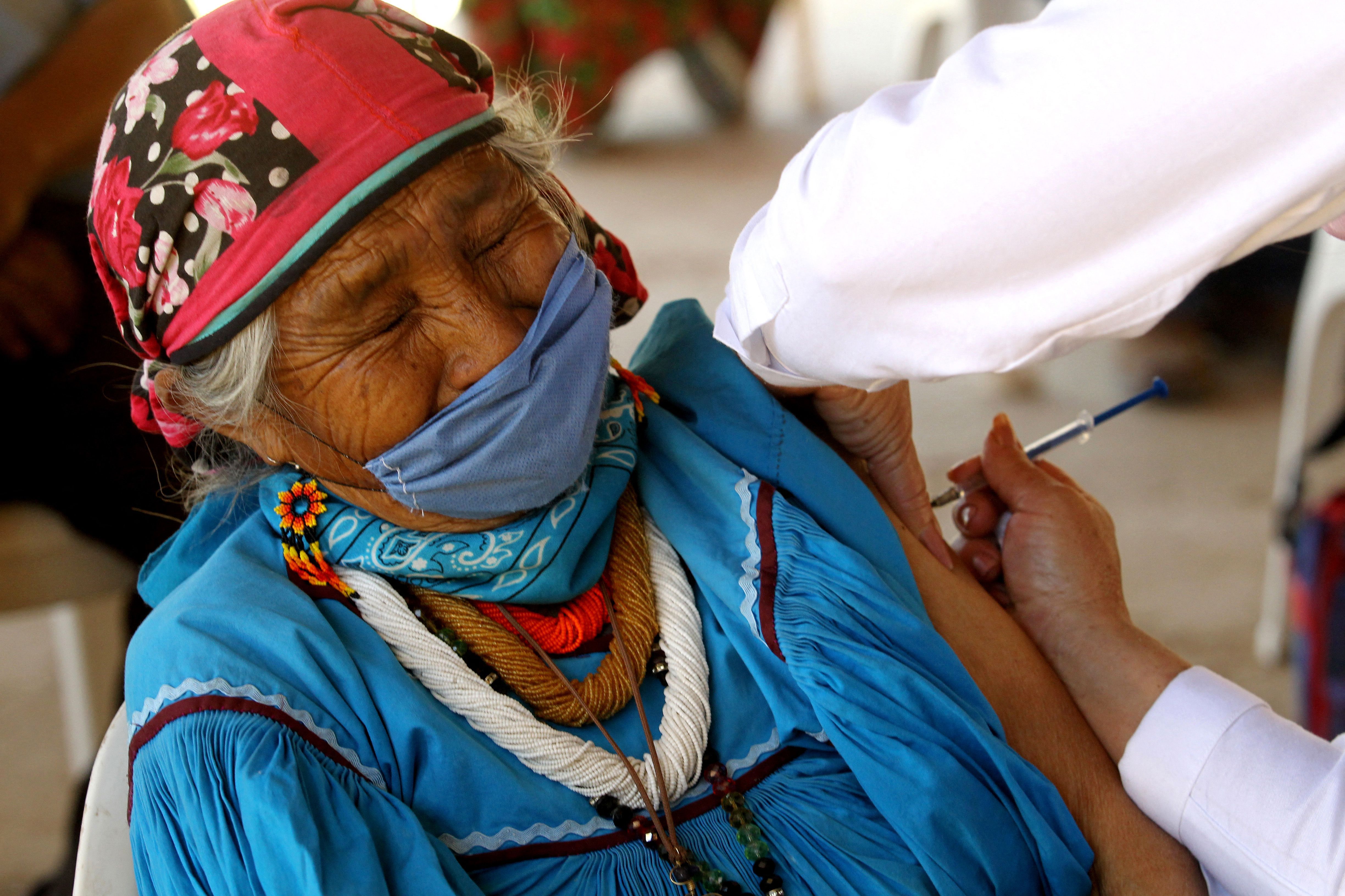 A Wixarica indigenous woman is inoculated against COVID-19 at the vaccination center installed in the town of Nuevo Colonia, in Mezquitic, Jalisco state, Mexico, on April 16