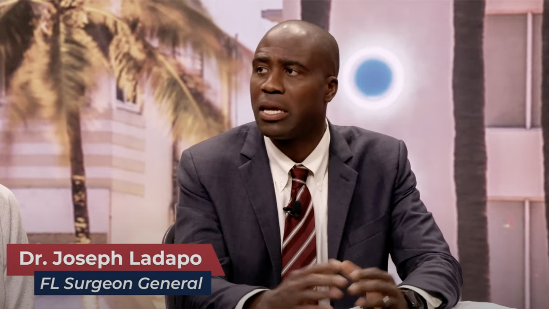 Dr Joseph Ladapo with his name on the screen underneath him