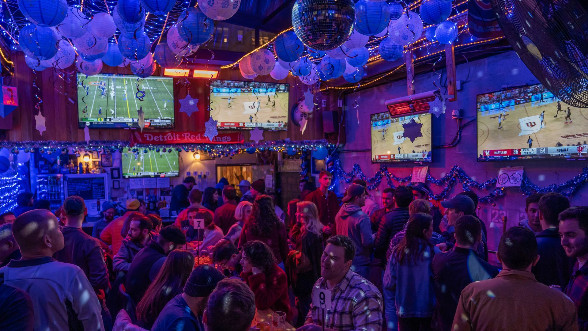 Blue Hanukkah decorations hang above the crowded back room at Ivy and Coney in Shaw.