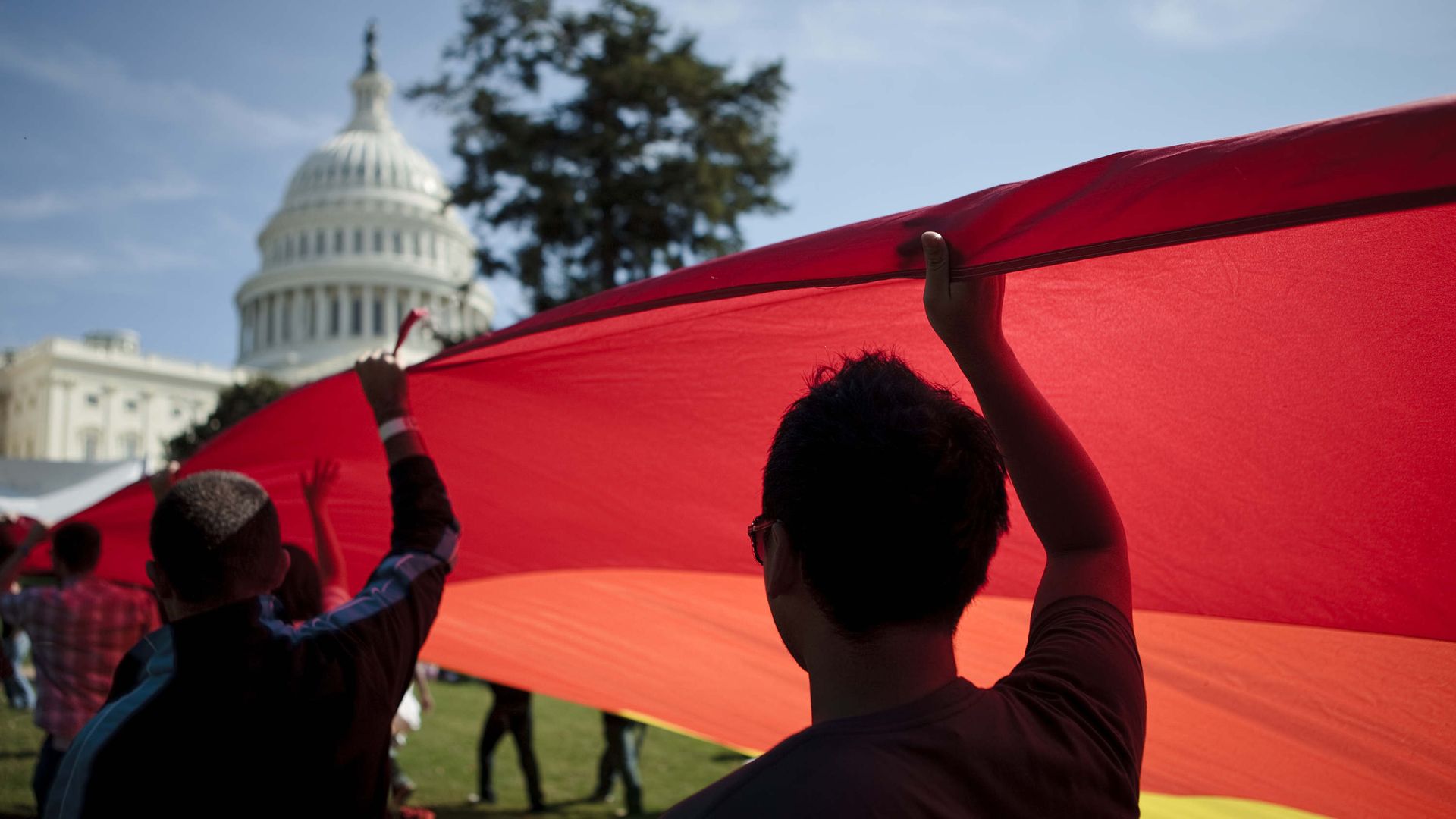 Activists carry a rainbow flag near the U.S. Capitol Building.