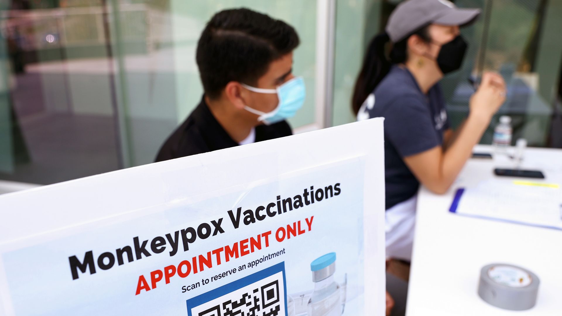 Health workers sit at a check-in table at a pop-up monkeypox vaccination clinic on August 3, 2022 in West Hollywood.