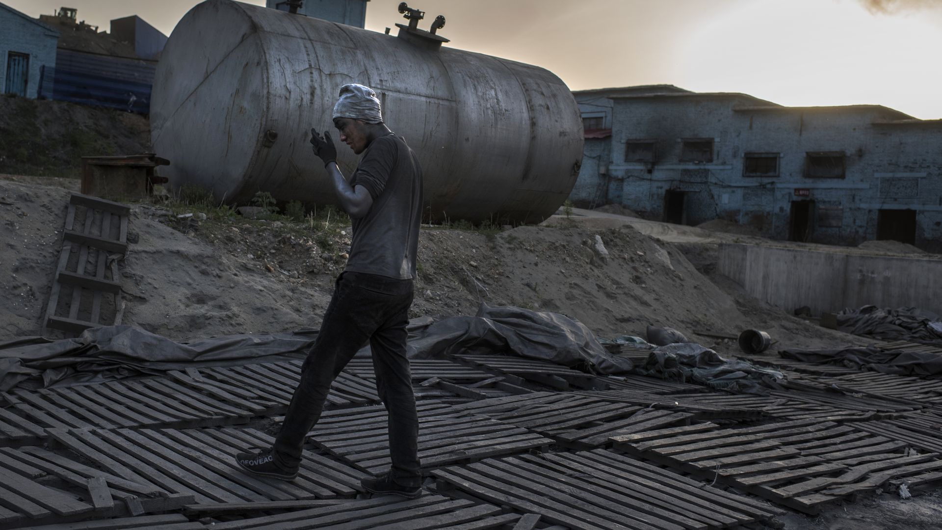 A worker walks across a Chinese graphite factory