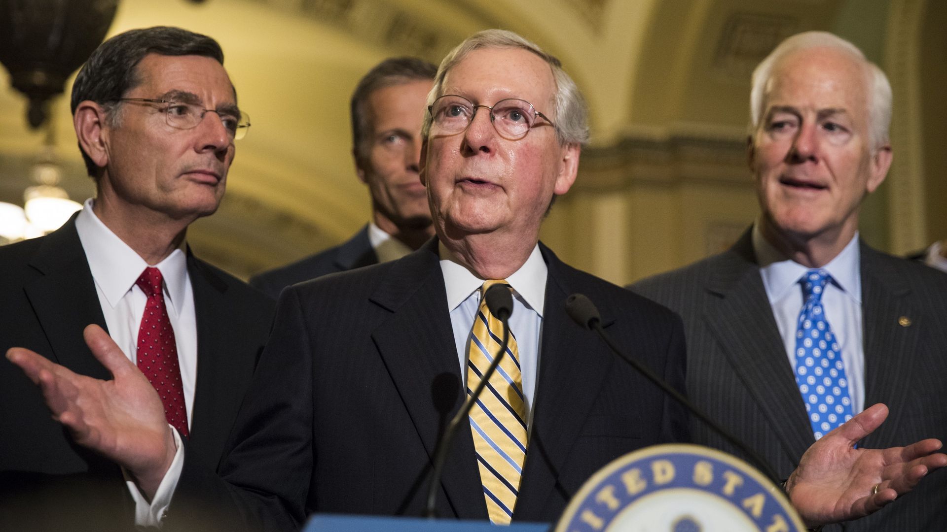 Senate Majority Leader Mitch McConnell (C) speaks with US Senators John Barrasso (L), John Cornyn (R) and John Thune 