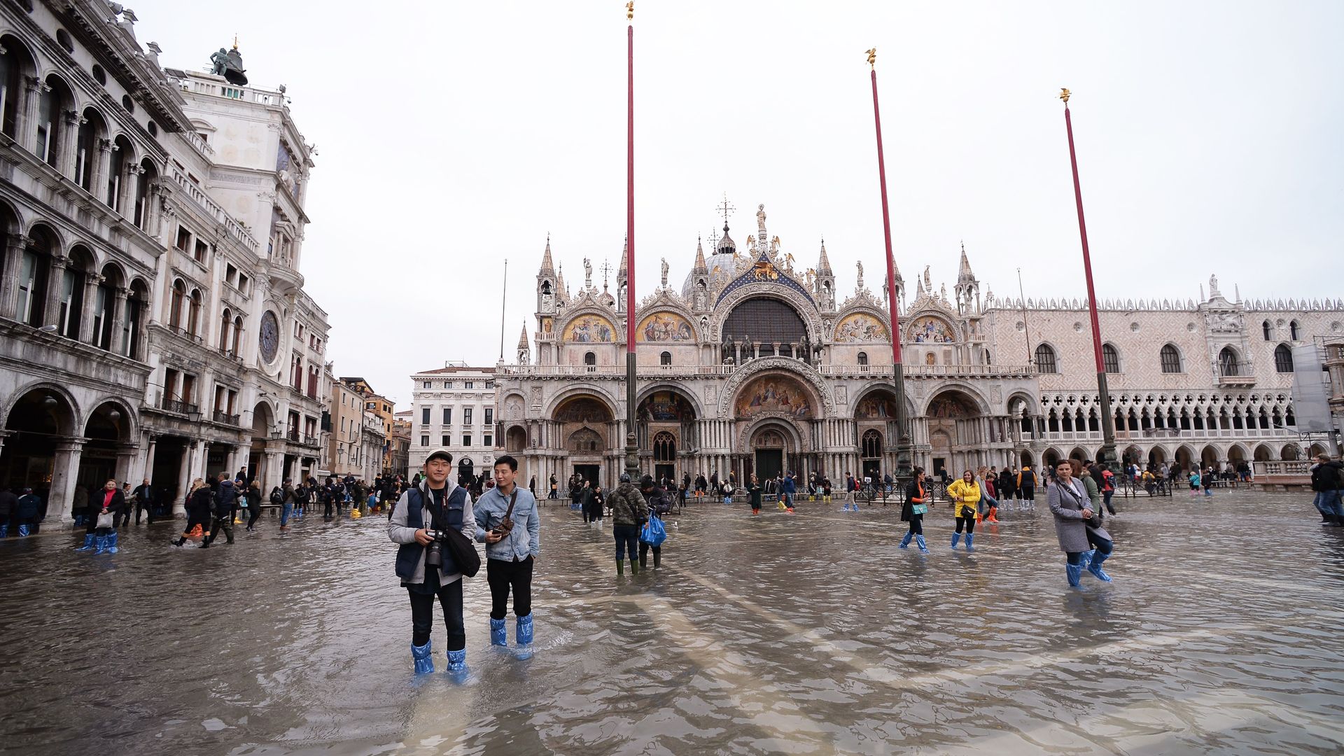 Tourists walking around a flooded Venice