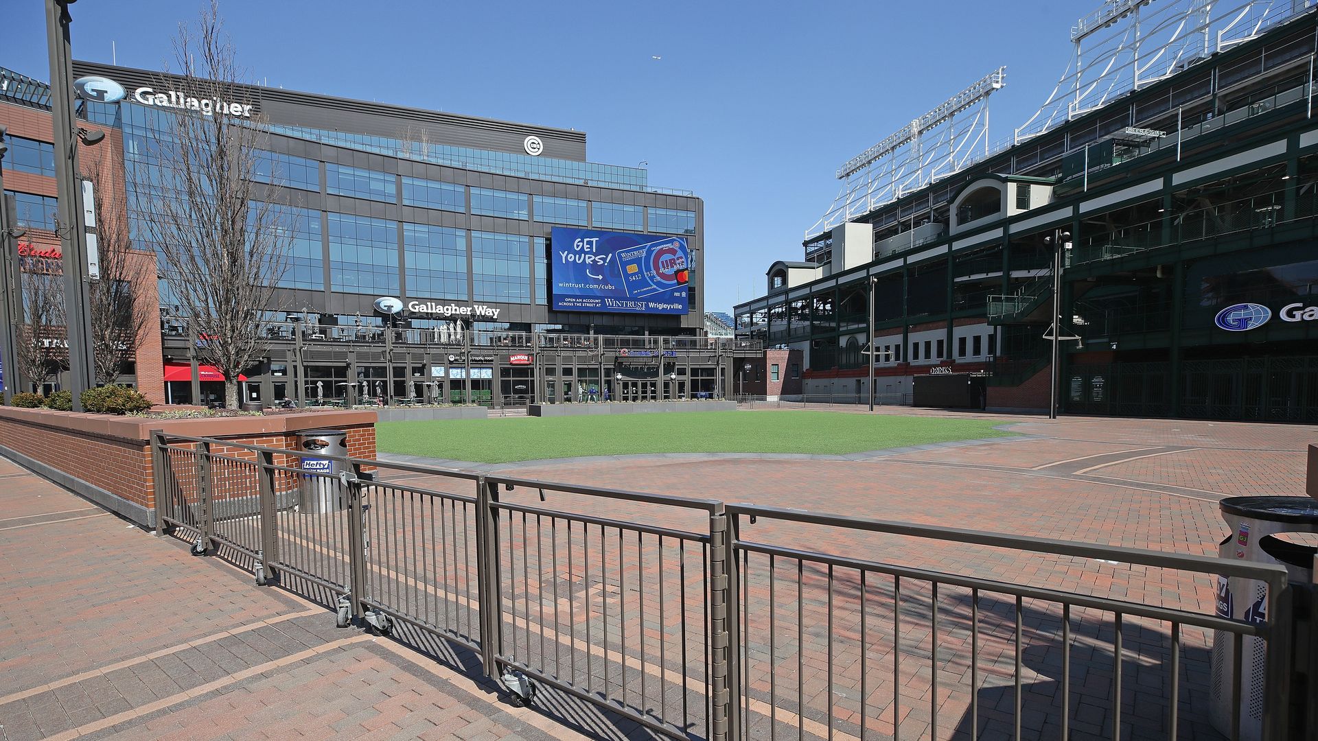 Photo of a baseball stadium iwth fences and space outside of it. 
