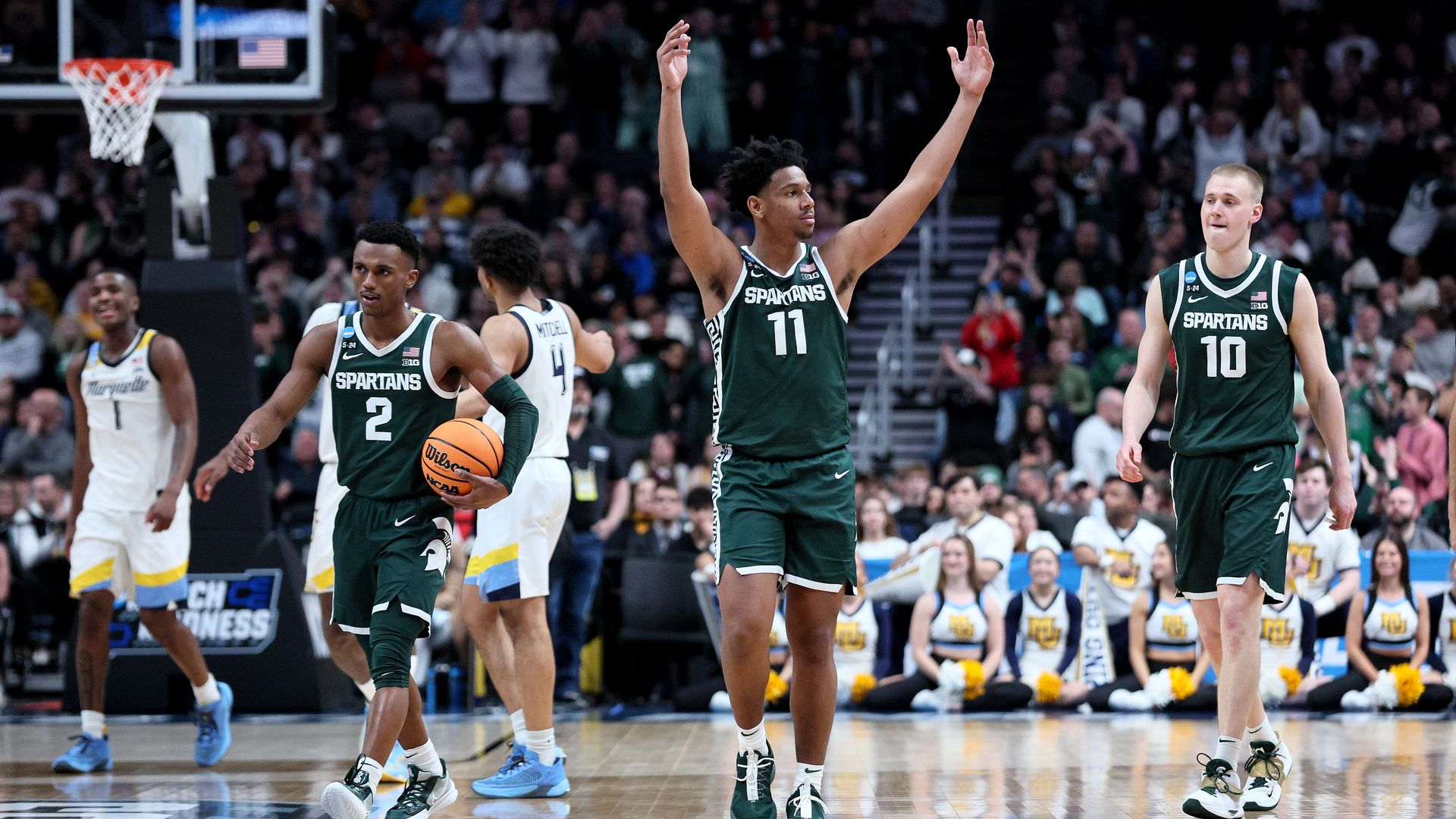 A.J. Hoggard, center, celebrates a play during MSU's win over Marquette.