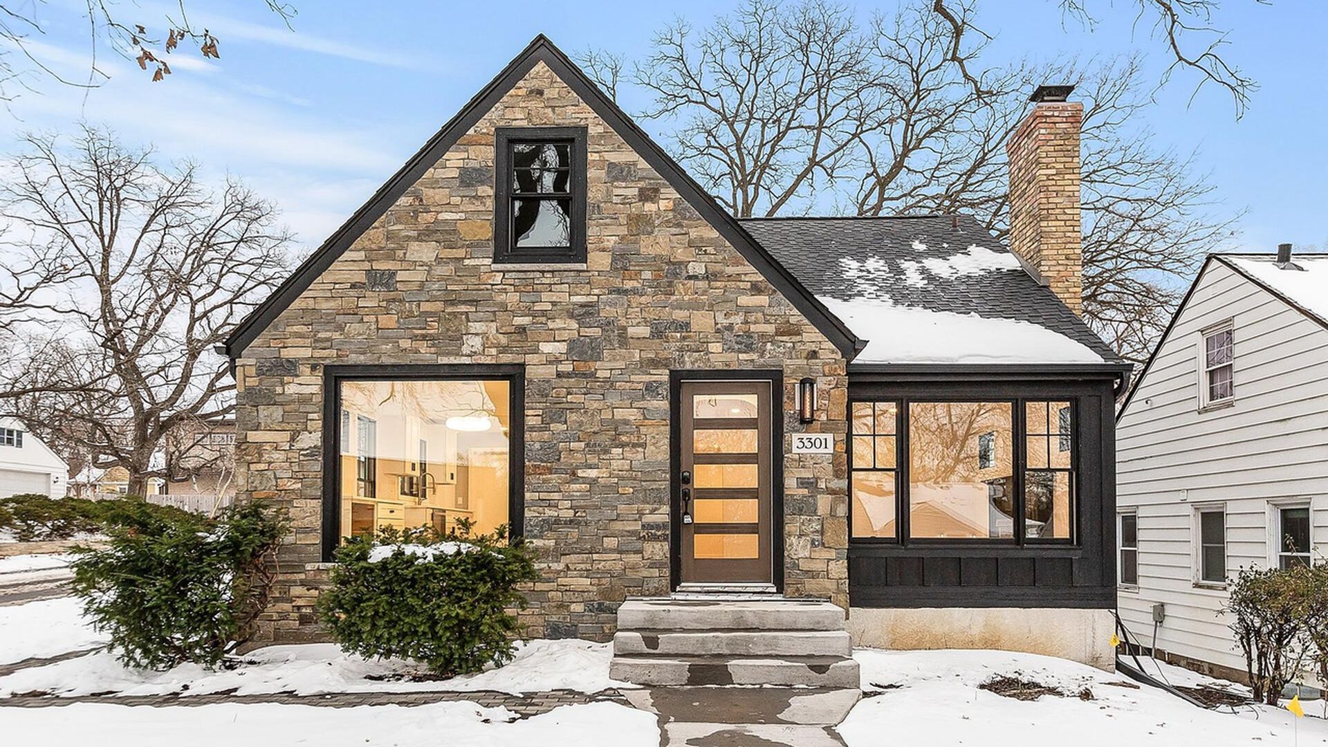 exterior of home with stone and dark paint