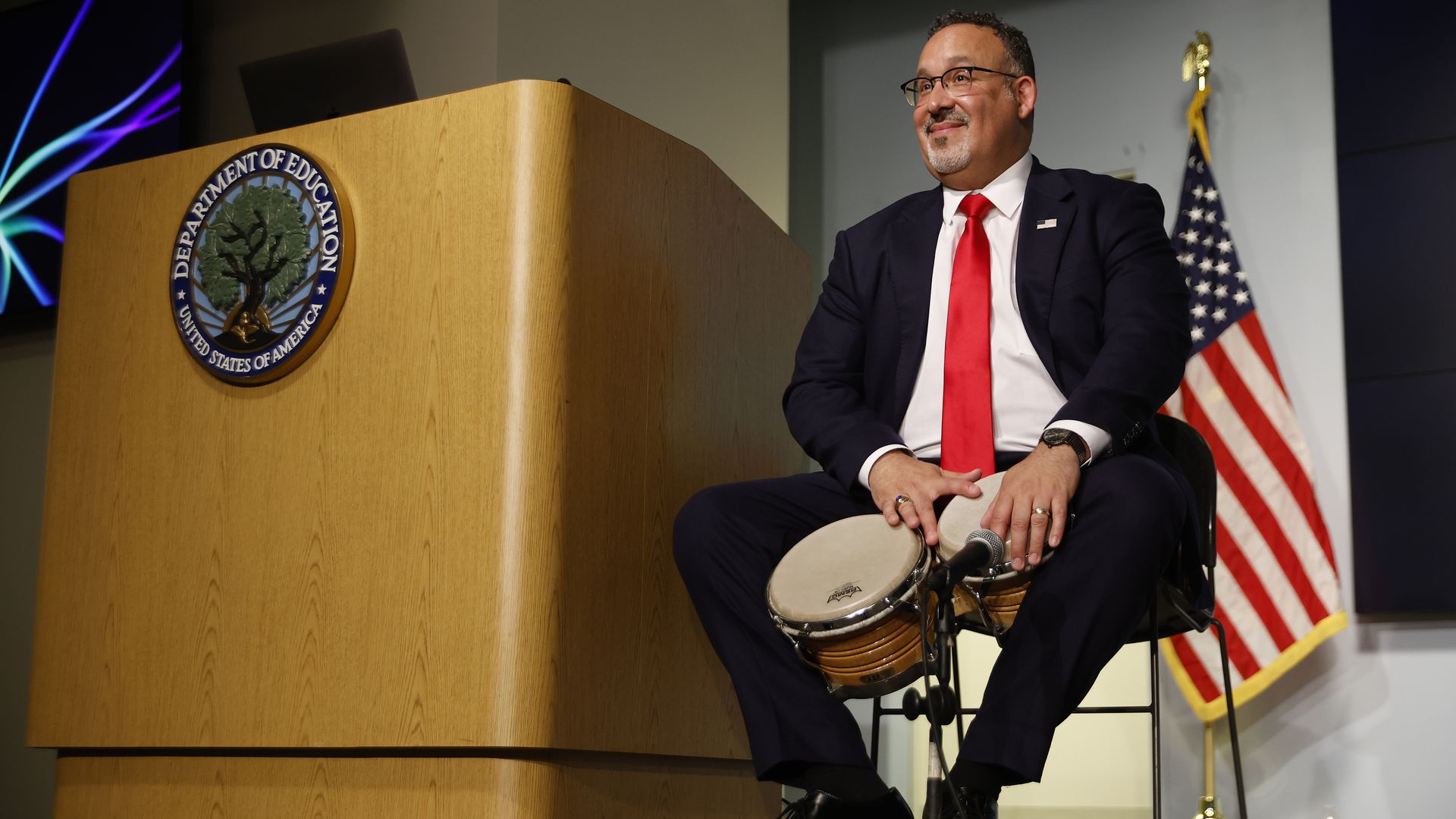 Education Secretary Miguel Cardona is seen playing a drum.