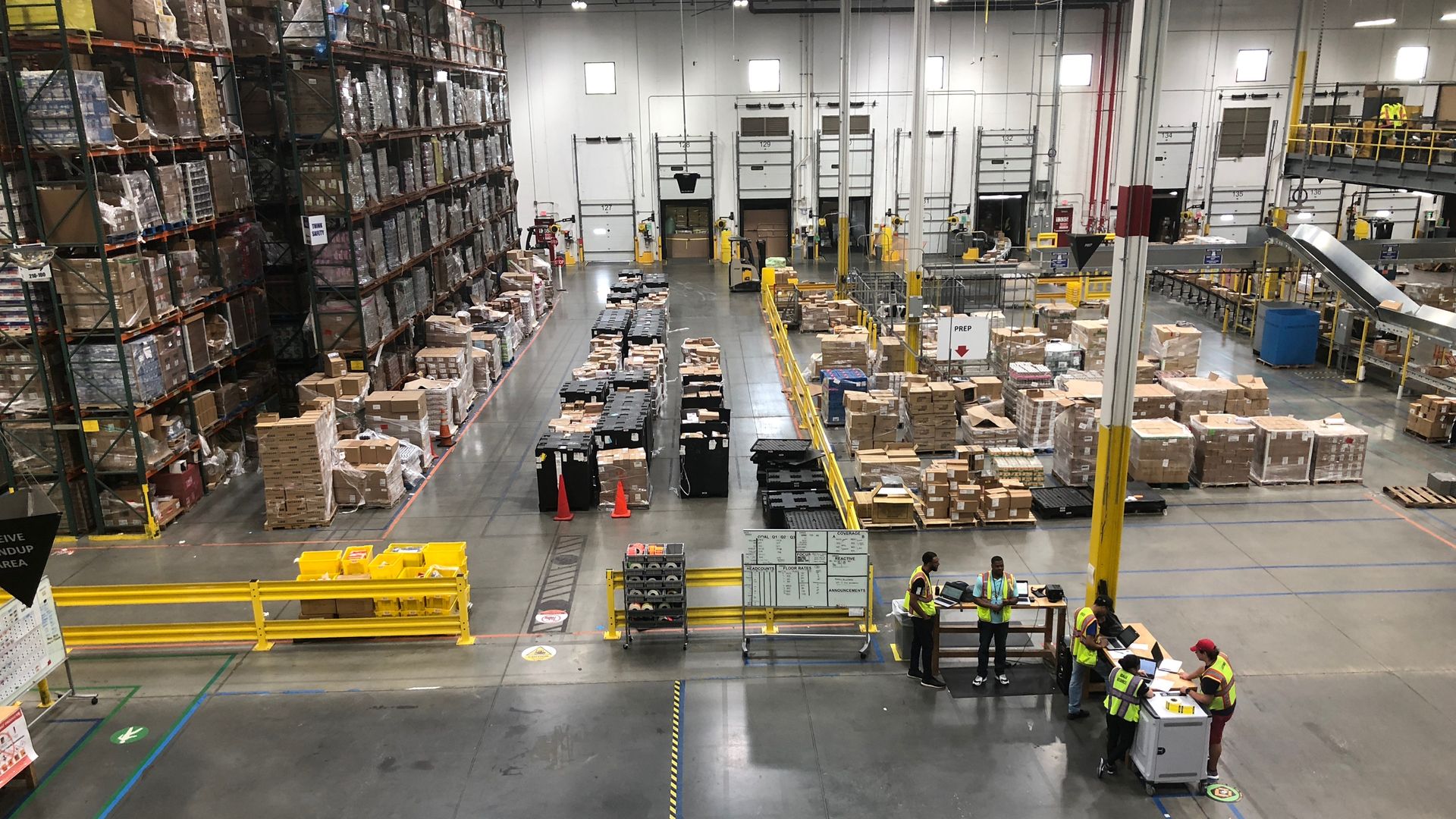 A bird's eye view of a warehouse with packages stacked high