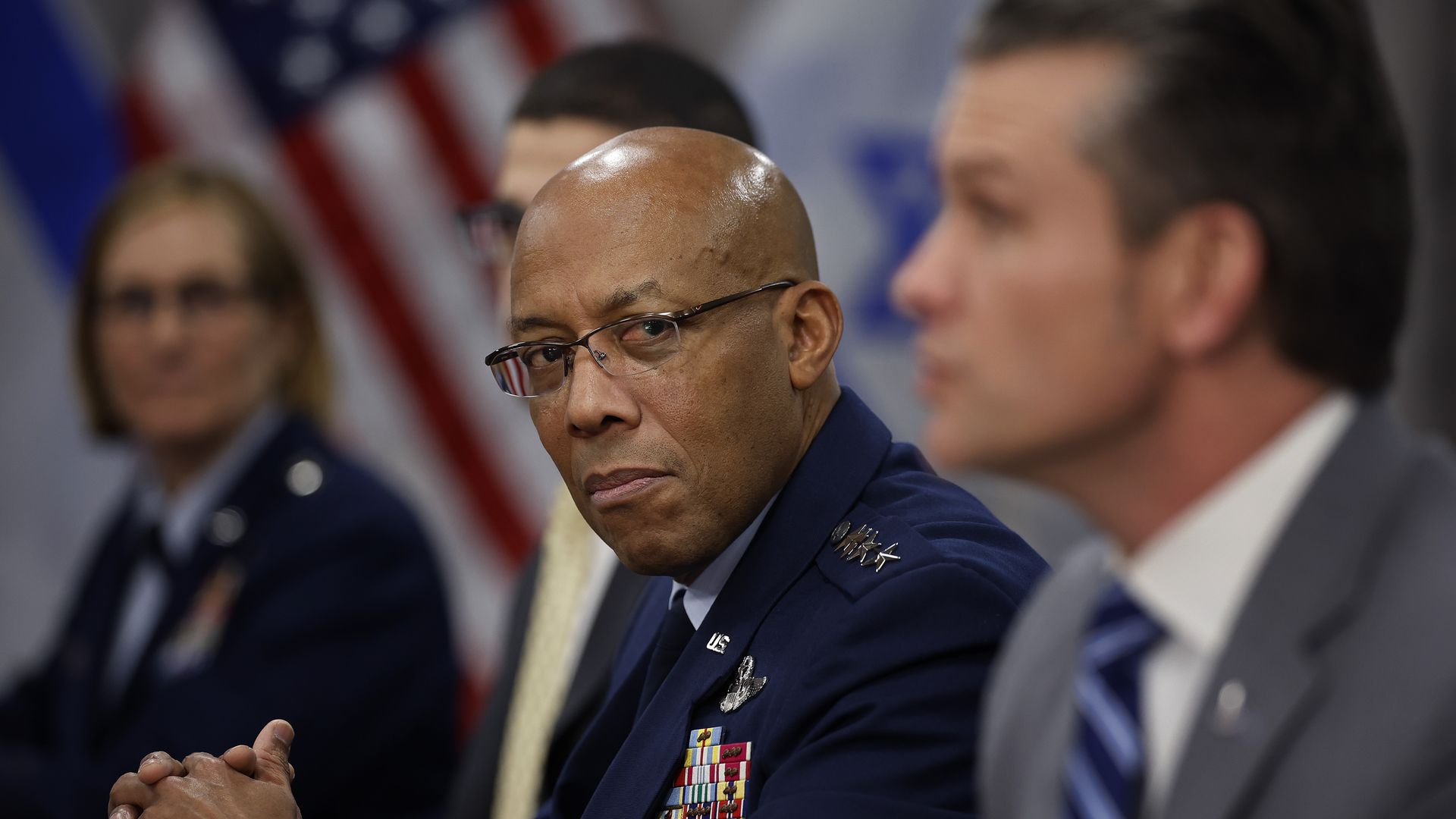 General Charles Brown Jr. listens to U.S. Secretary of Defense Pete Hegseth answer reporters' (not pictured) questions.