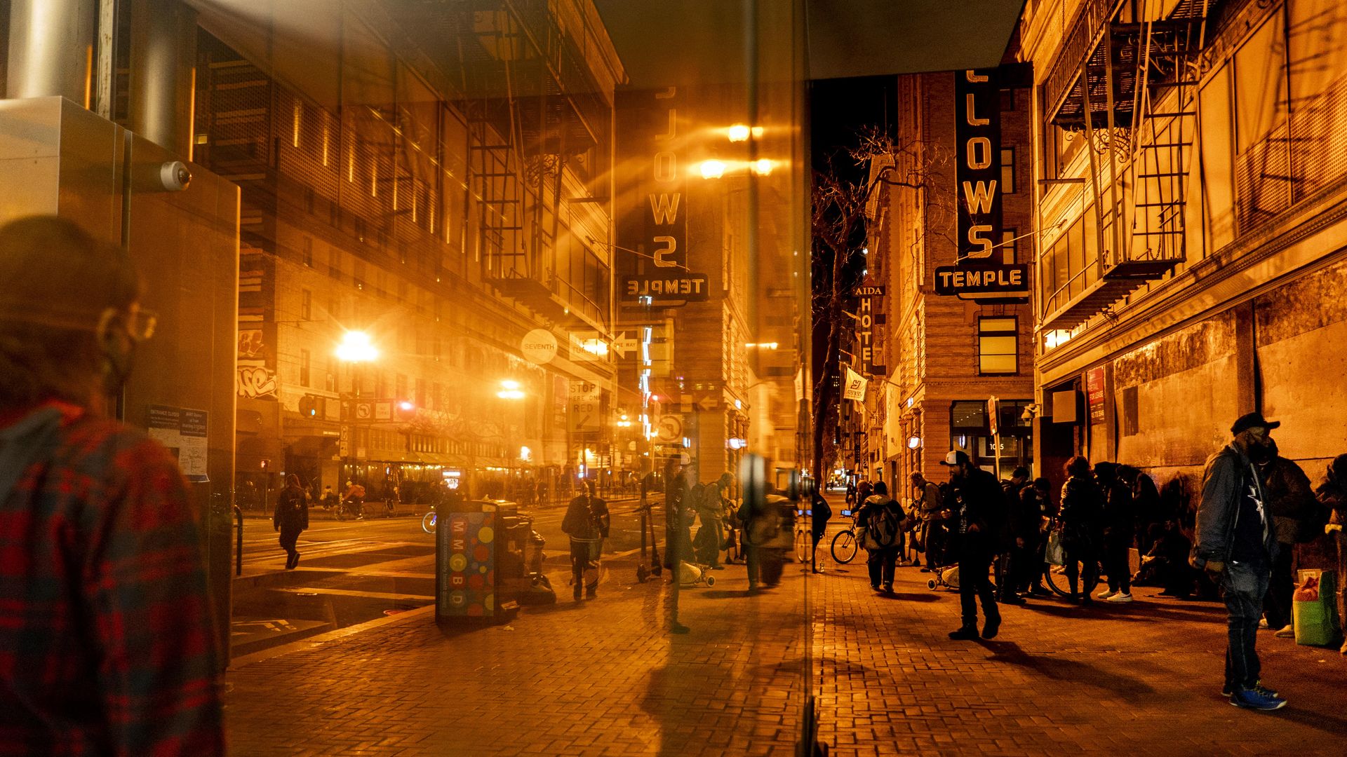 Photo of a Tenderloin alleyway with people walking in the nighttime