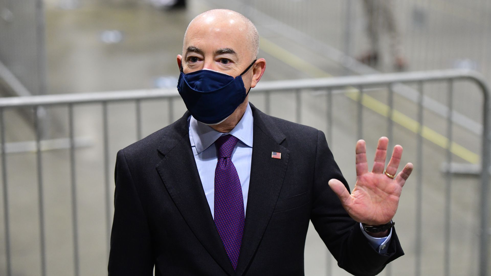 Secretary of Homeland Security Alejandro Mayorkas waves while visiting a FEMA community vaccination center