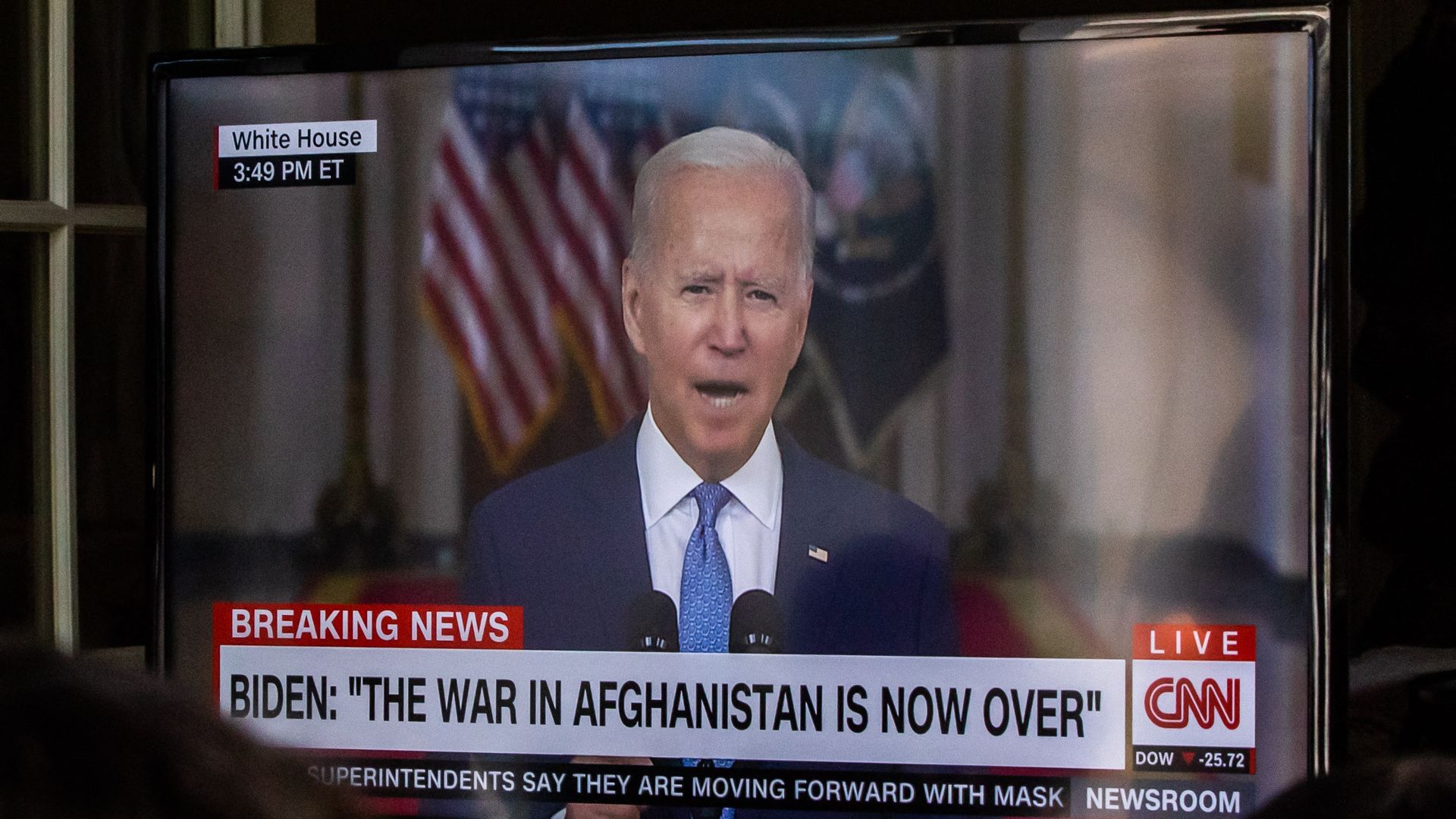 A group of military families and veterans watch President Joe Biden's speech announcing that all troops are out of Afghanistan, on August 31, 2021.