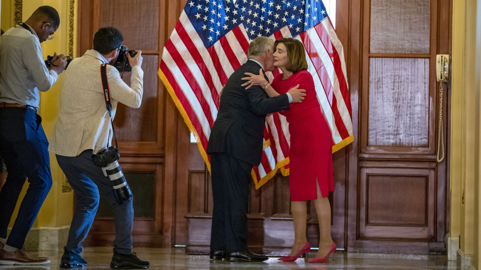 Photographers are seen capturing House Speaker Nancy Pelosi as she welcomes Jordan's King Abdullah to the Capitol.