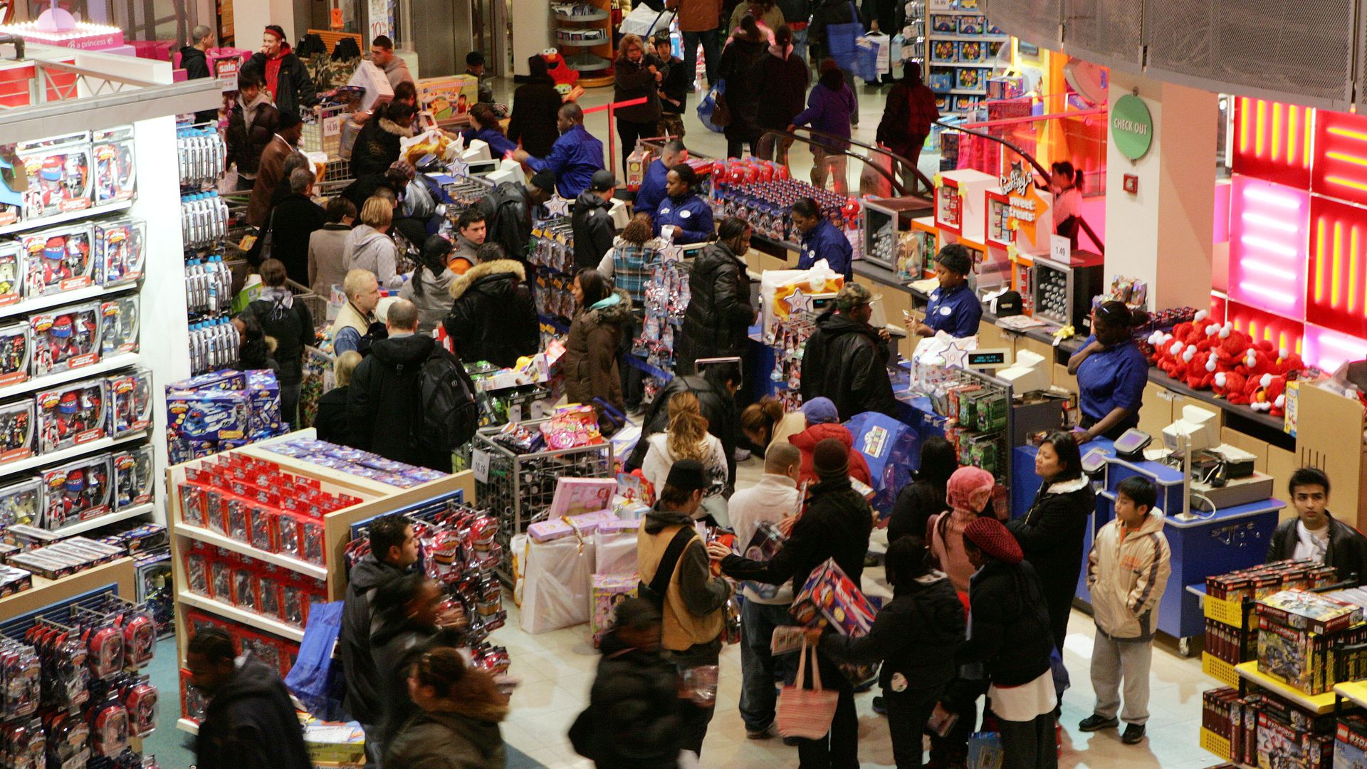 Early shoppers wait online to pay for their goods at the Toys 'R' Us at Times Square.
