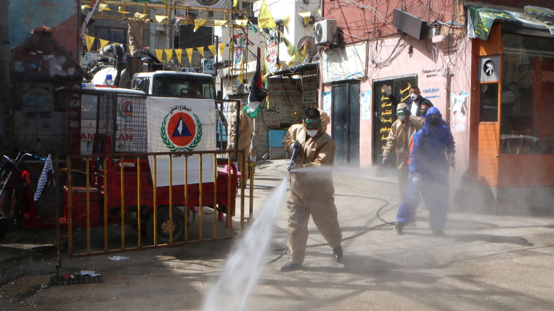 A photo of people disinfecting the refugee camp