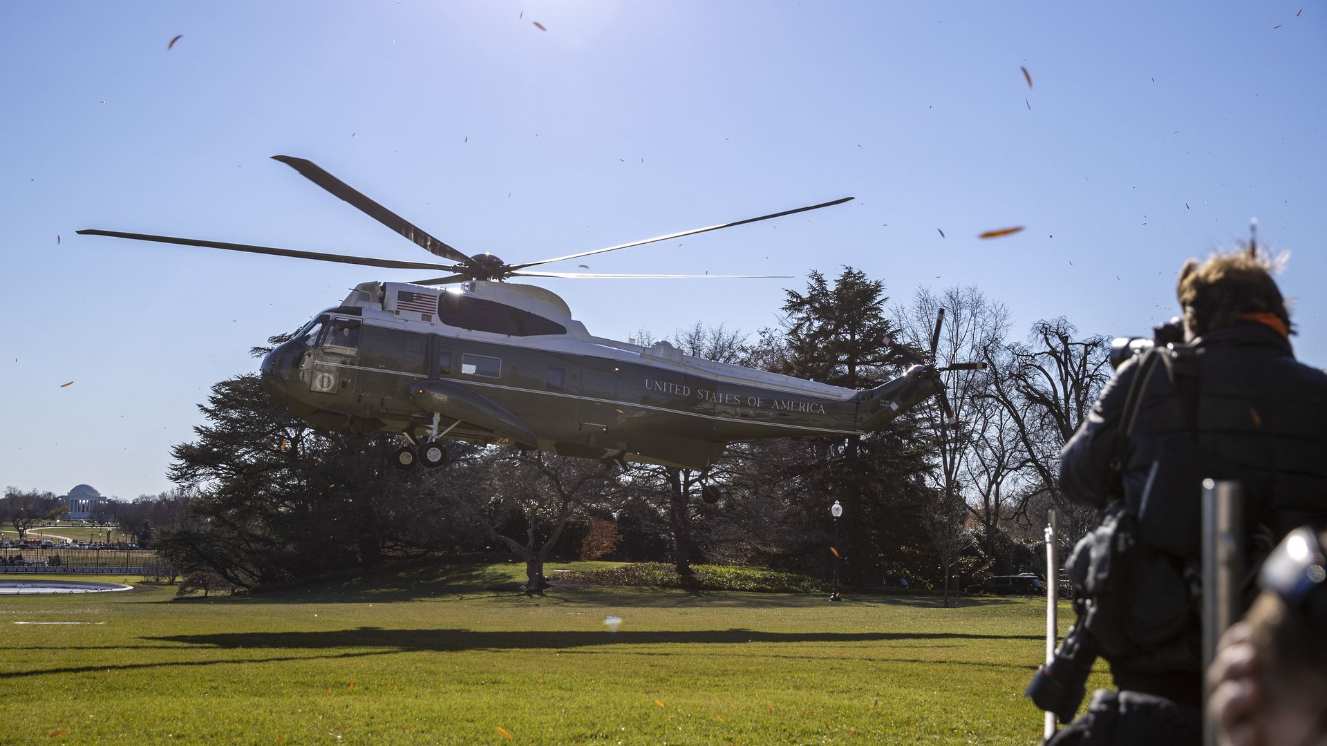 Marine One is seen kicking up leaves as it lands on the South Lawn.