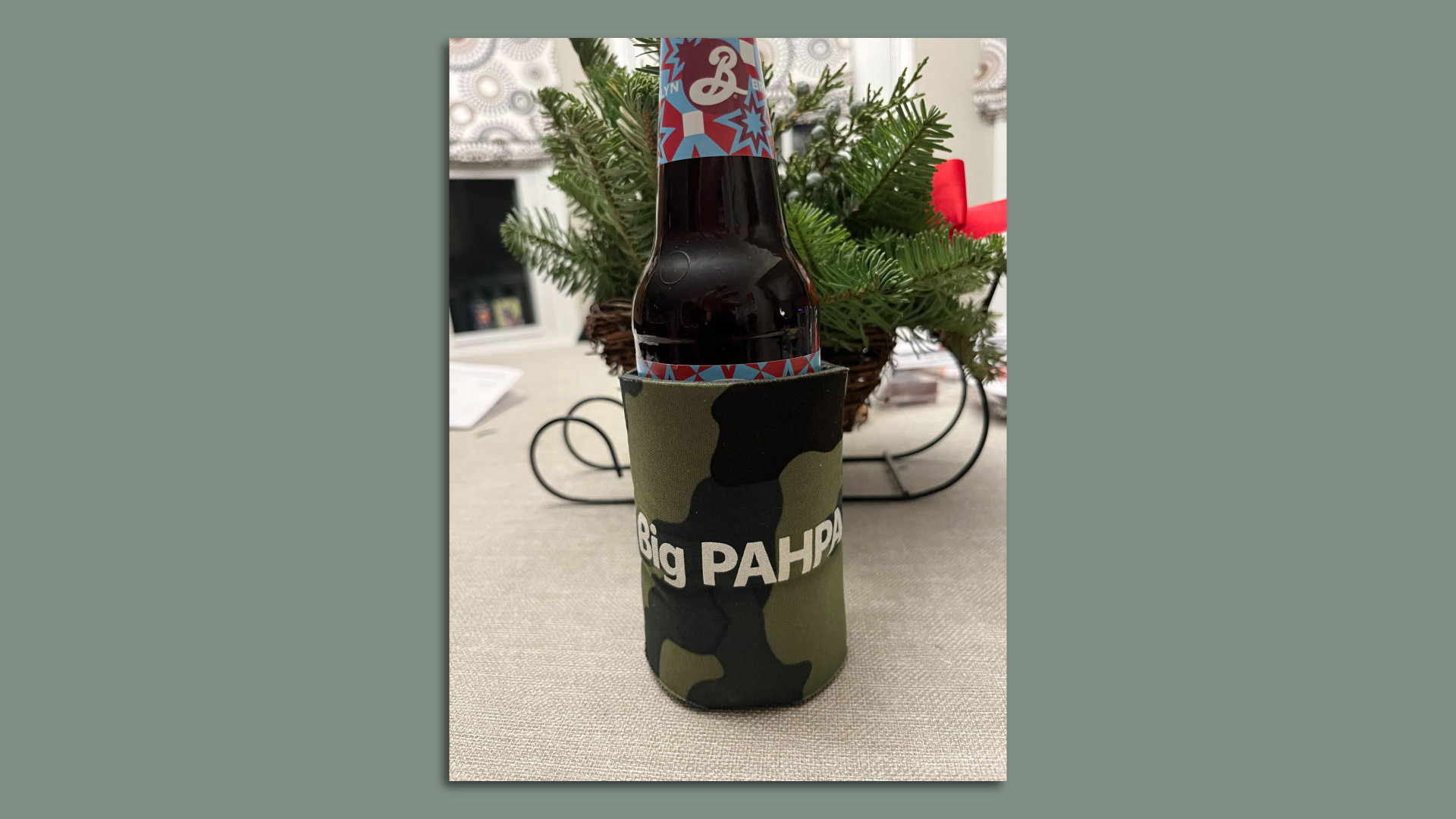 Image of a beer bottle in a drink koozie that reads "Big PAHPA"