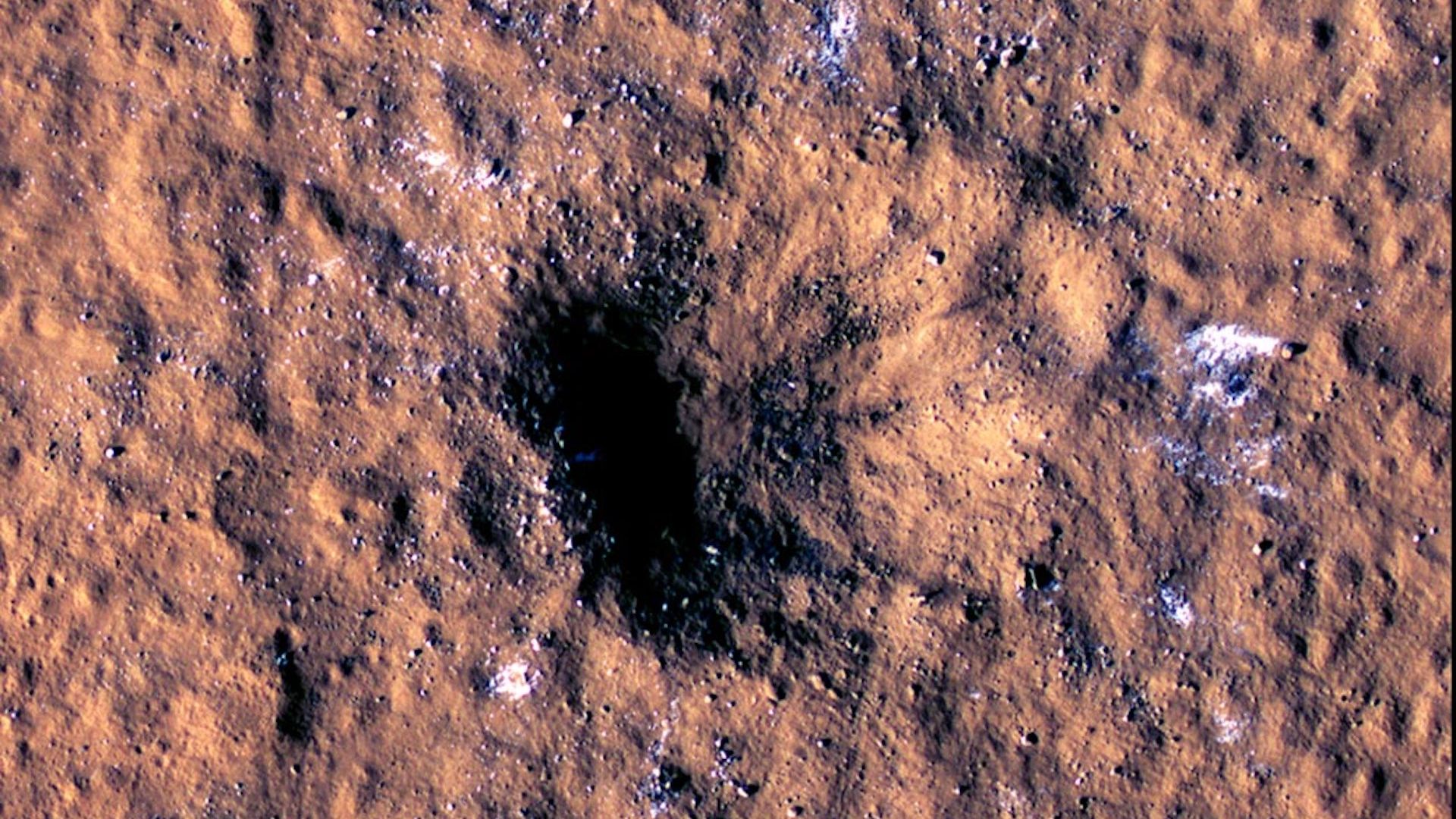 A meteor impact (dark hole) seen on Mars 