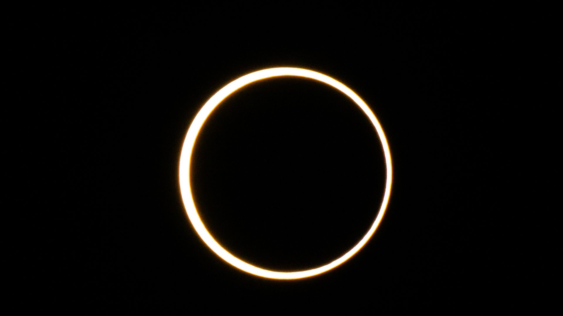 The moon descends over the sun's horizon during an annular solar eclipse on October 14, 2023 in Kerrville, Texas. 