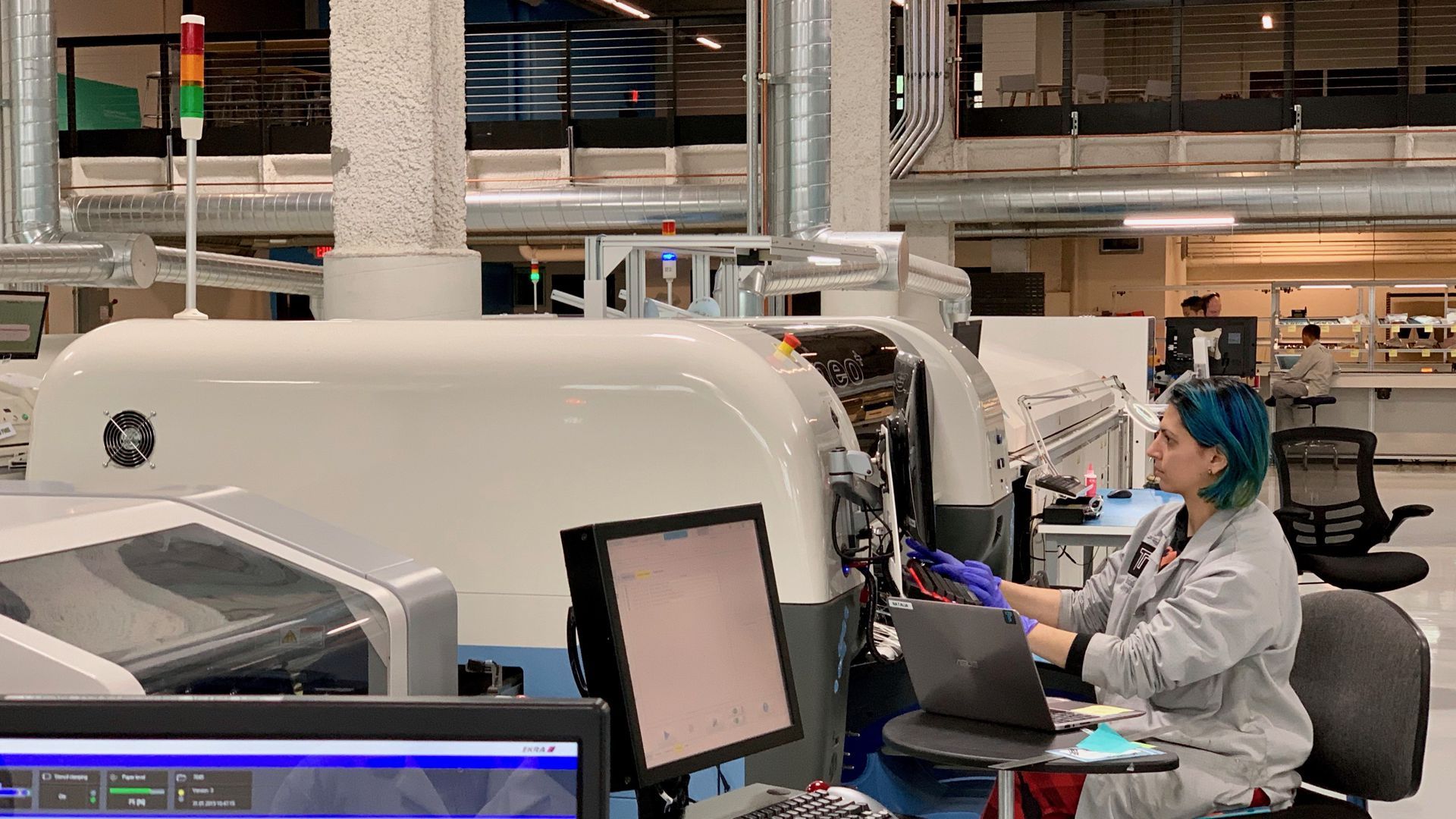 A photo of a woman operating a large machine