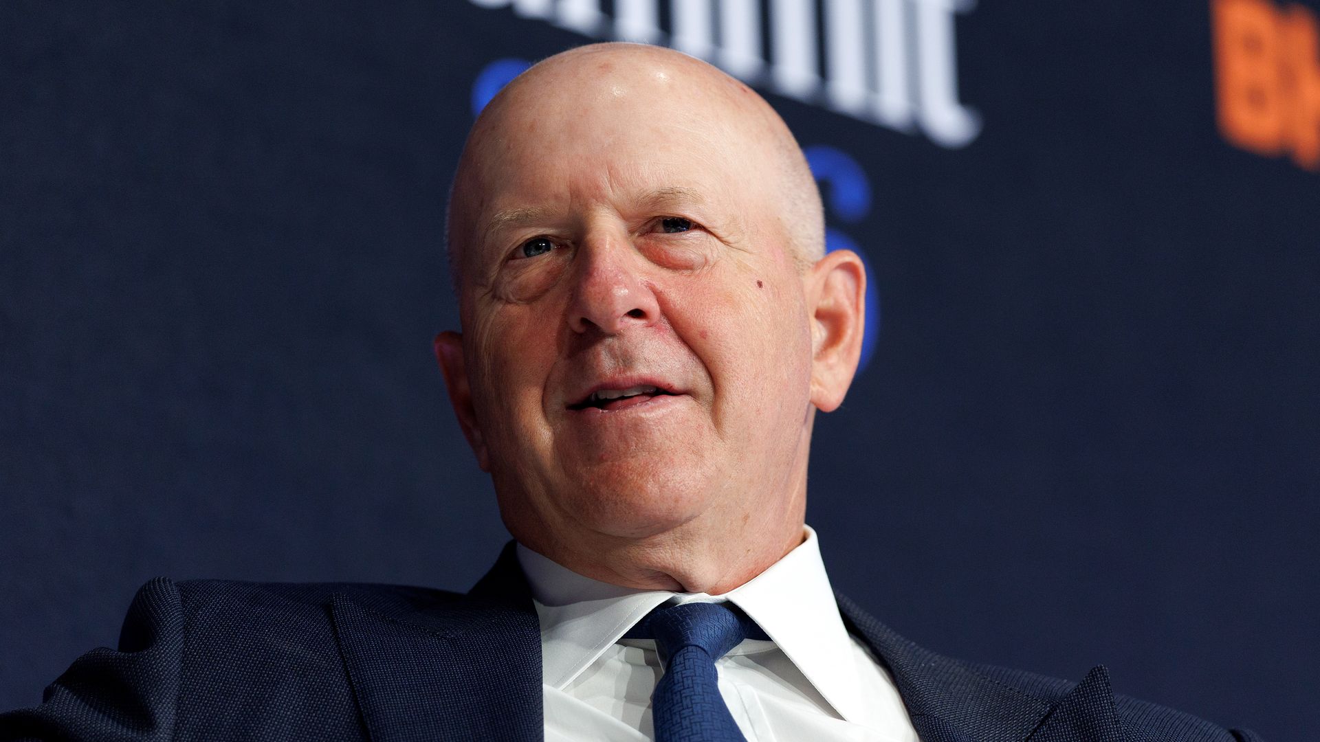 Goldman Sachs CEO David Solomon, seated on a stage with the word "summit" on a backdrop over his head. 