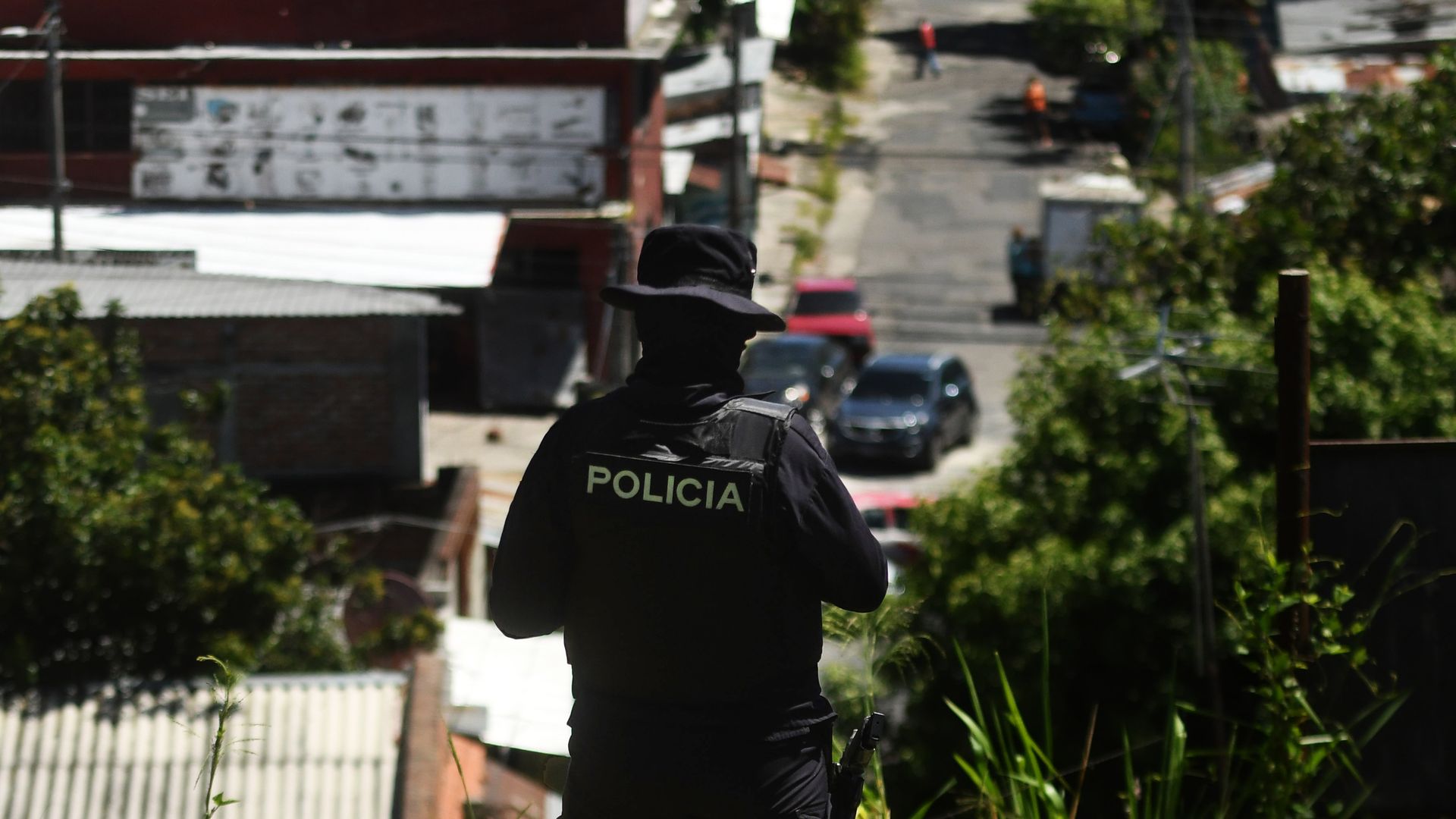 A police officer patrols an area beset by gang members in San Salvador.