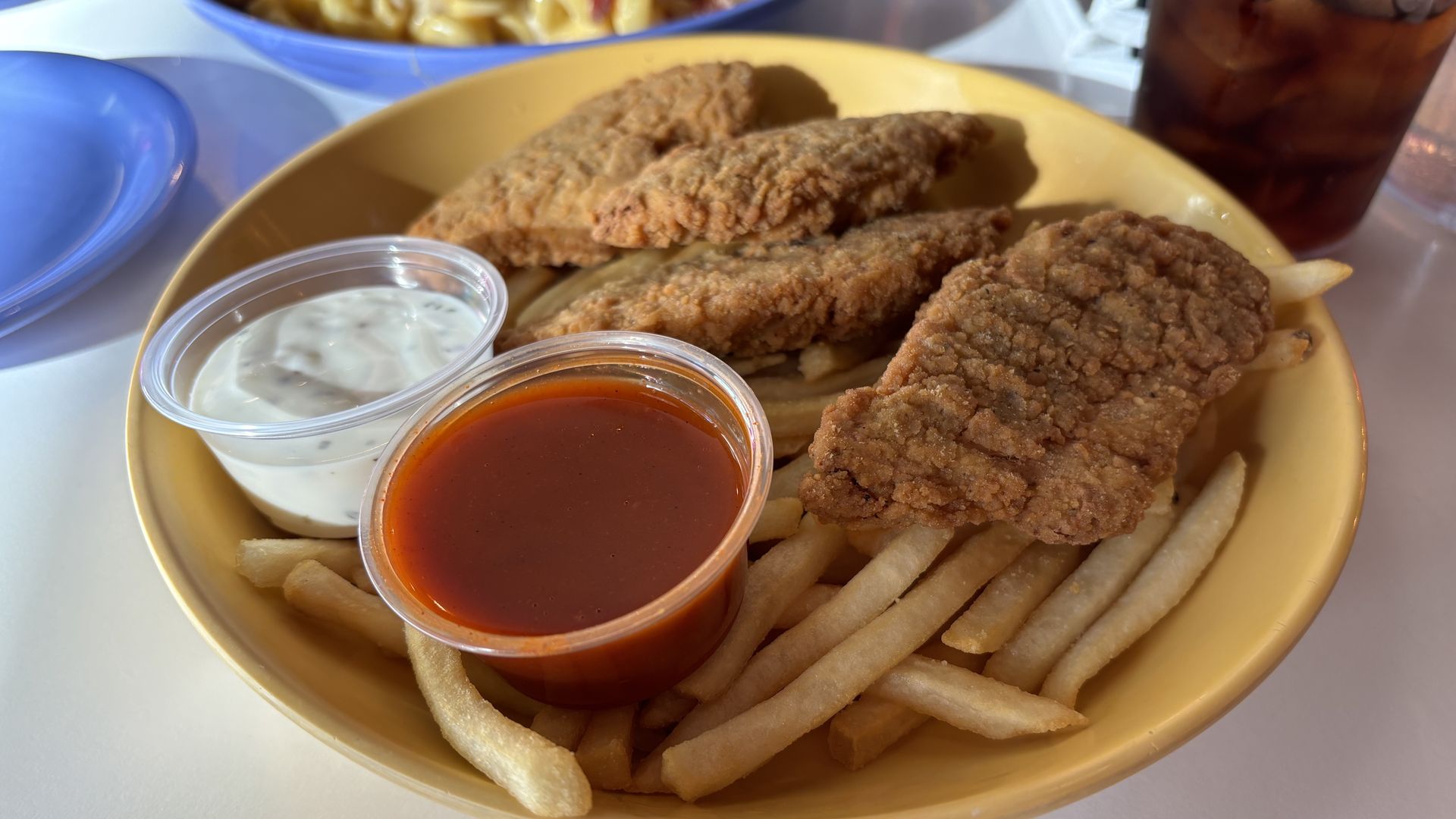 A plate of chicken tenders and fries