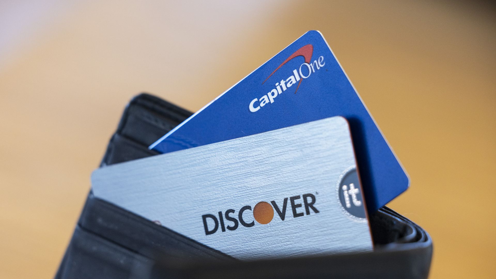 image of Discover and Capital One cards in a wallet.
