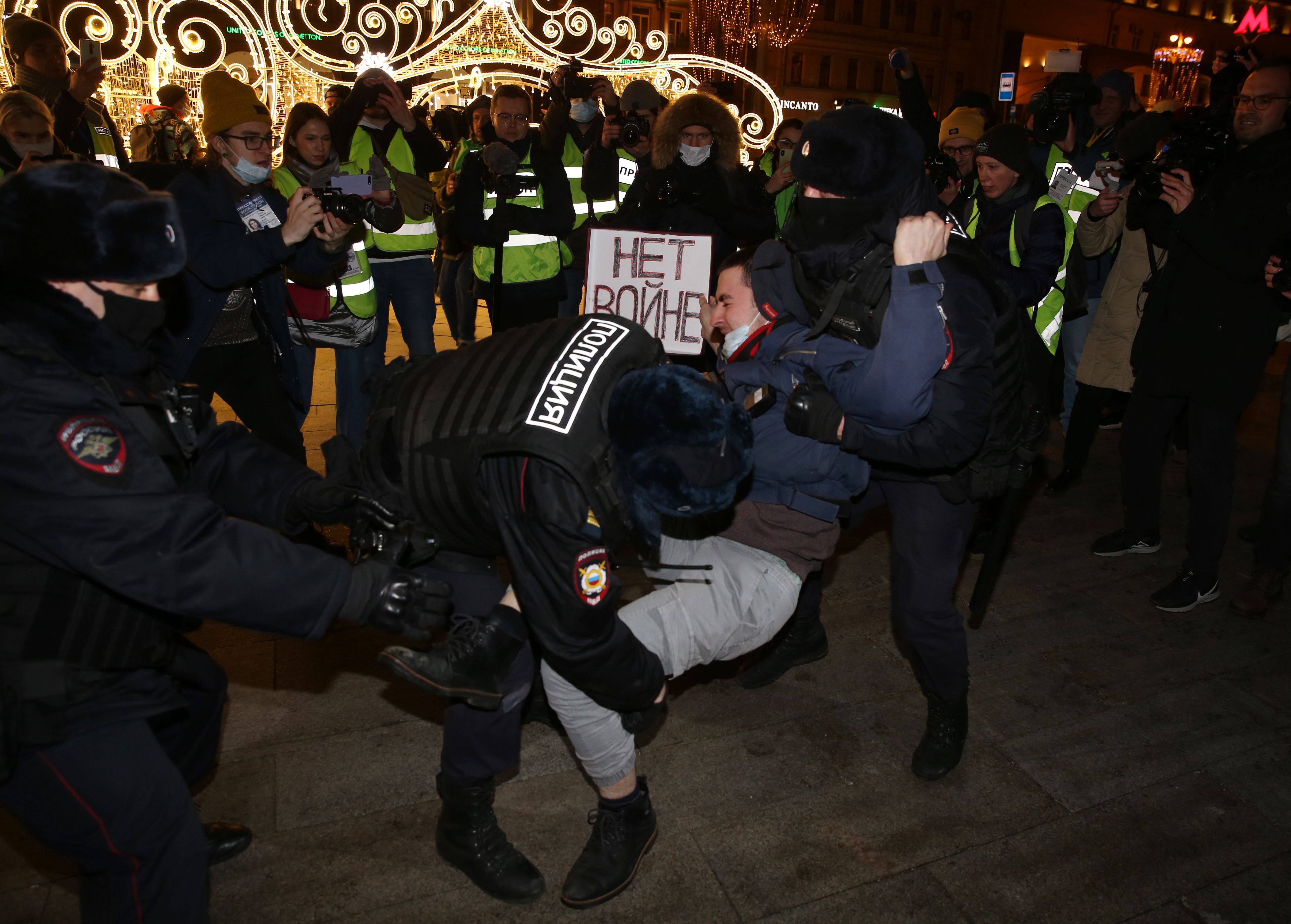 Police officers detain a man holding a placard reading "No war" during a protest at Pushkinskaya Square on February 24, 2022 in Moscow, Russia. 