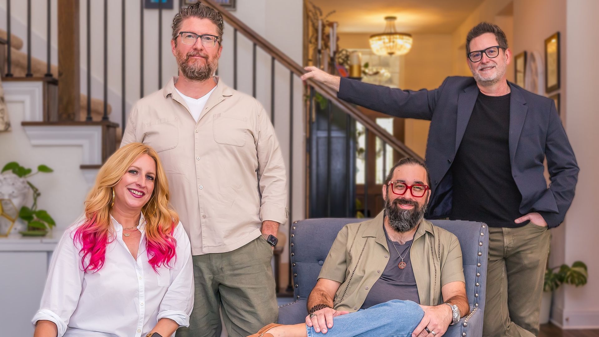 From left to right: Jayne Bodmann, Christopher Bodmann, B.J. Bell and Joseph Guyer, founders of Inbound Books. They are posed in a bright living room in front of a staircase.