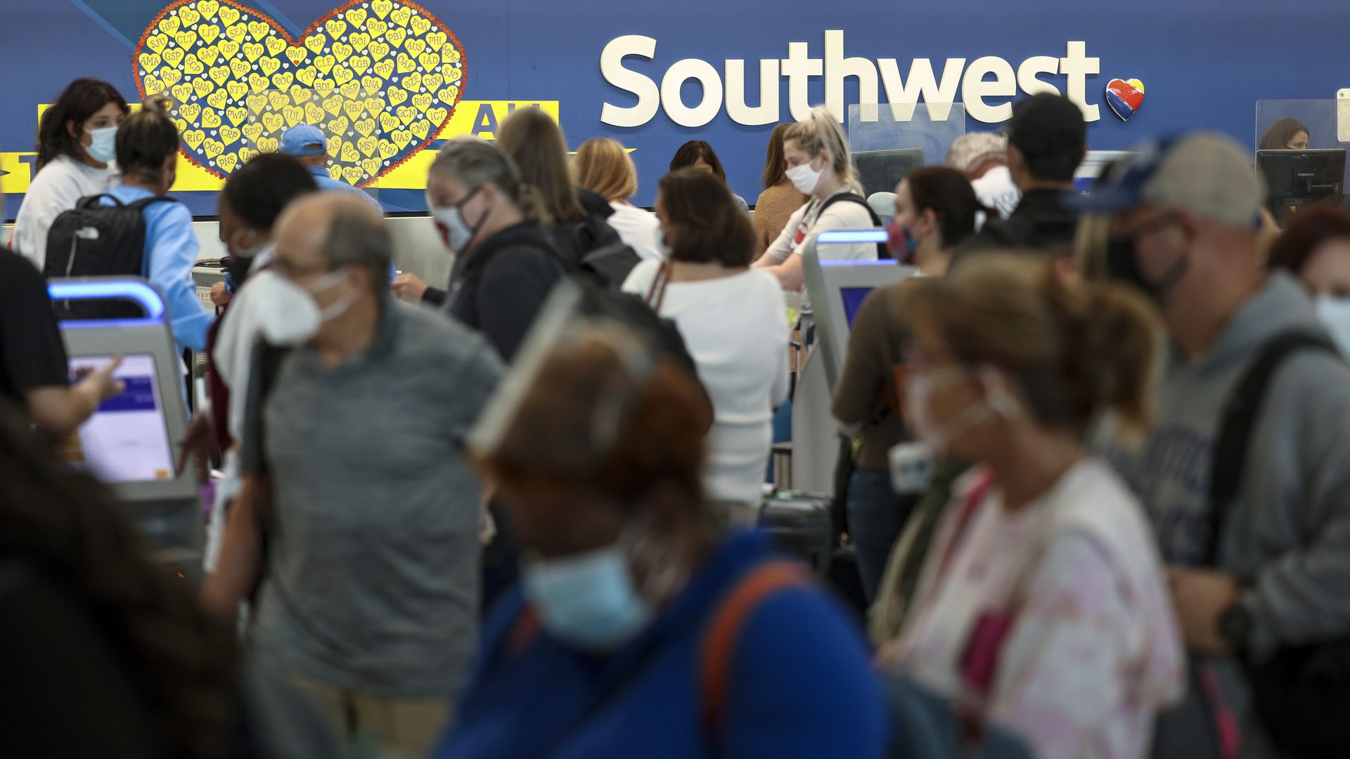 Travelers wait to check in at the Southwest Airlines ticketing counter at Baltimore Washington International Thurgood Marshall Airport on October 11, 2021 in Baltimore, Maryland