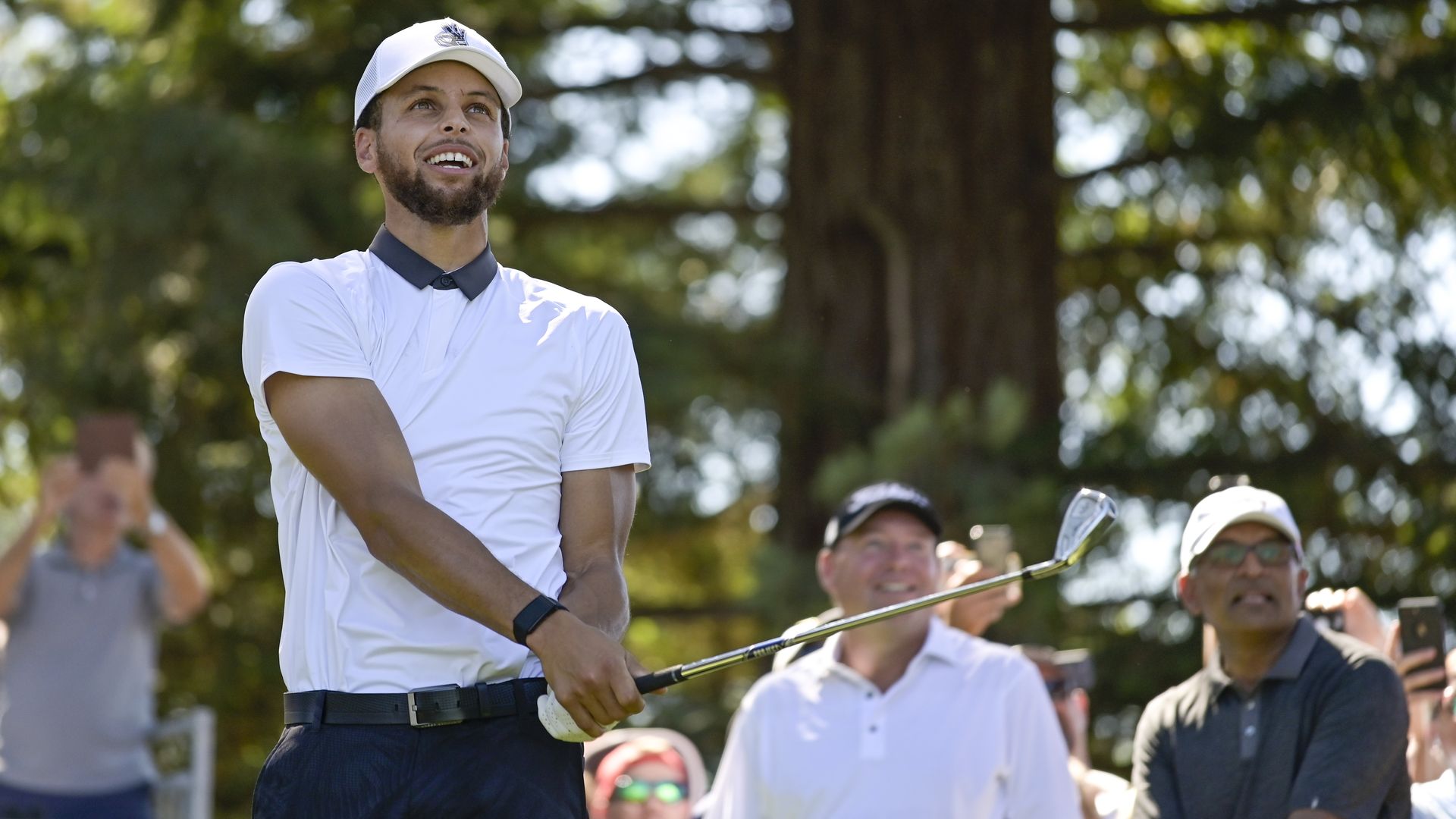 Steph Curry swinging a golf club