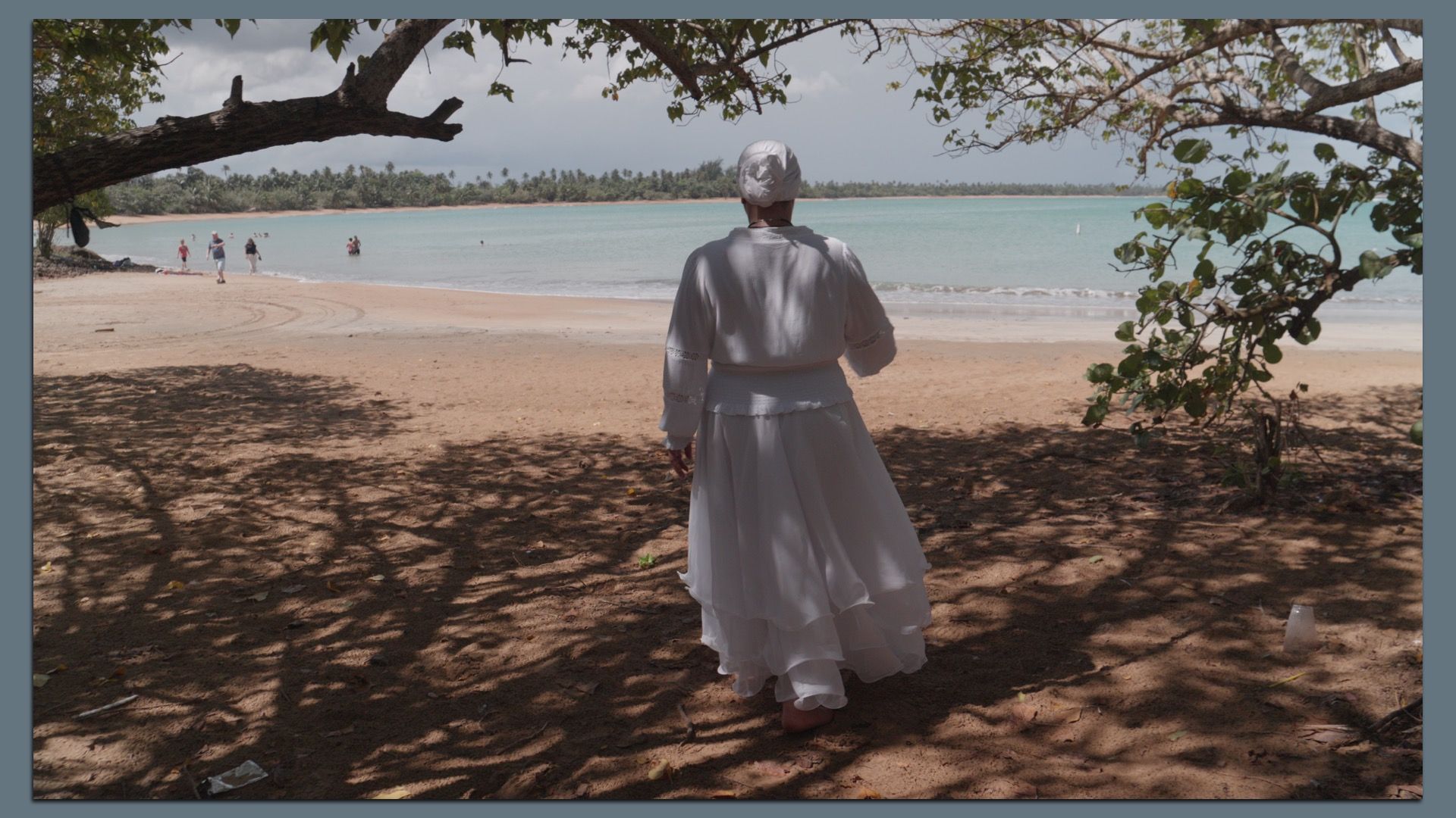 Philly artist Wanda Raimundi Ortiz standing and looking out on a beach in Puerto Rico in March 2025.