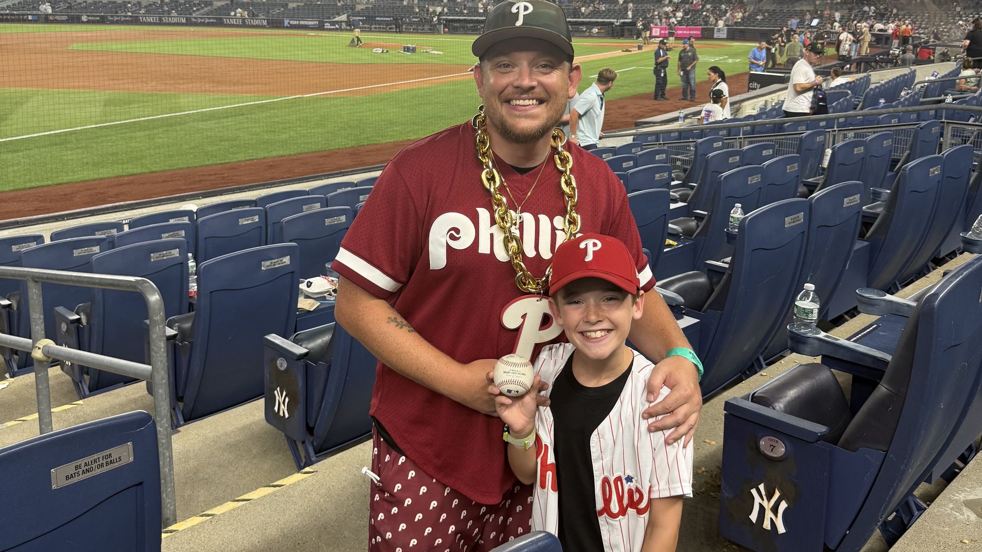 Sports gambling influencer Patrick "Maniac" Malloy with his son, Finn, at Citizens Bank Park.