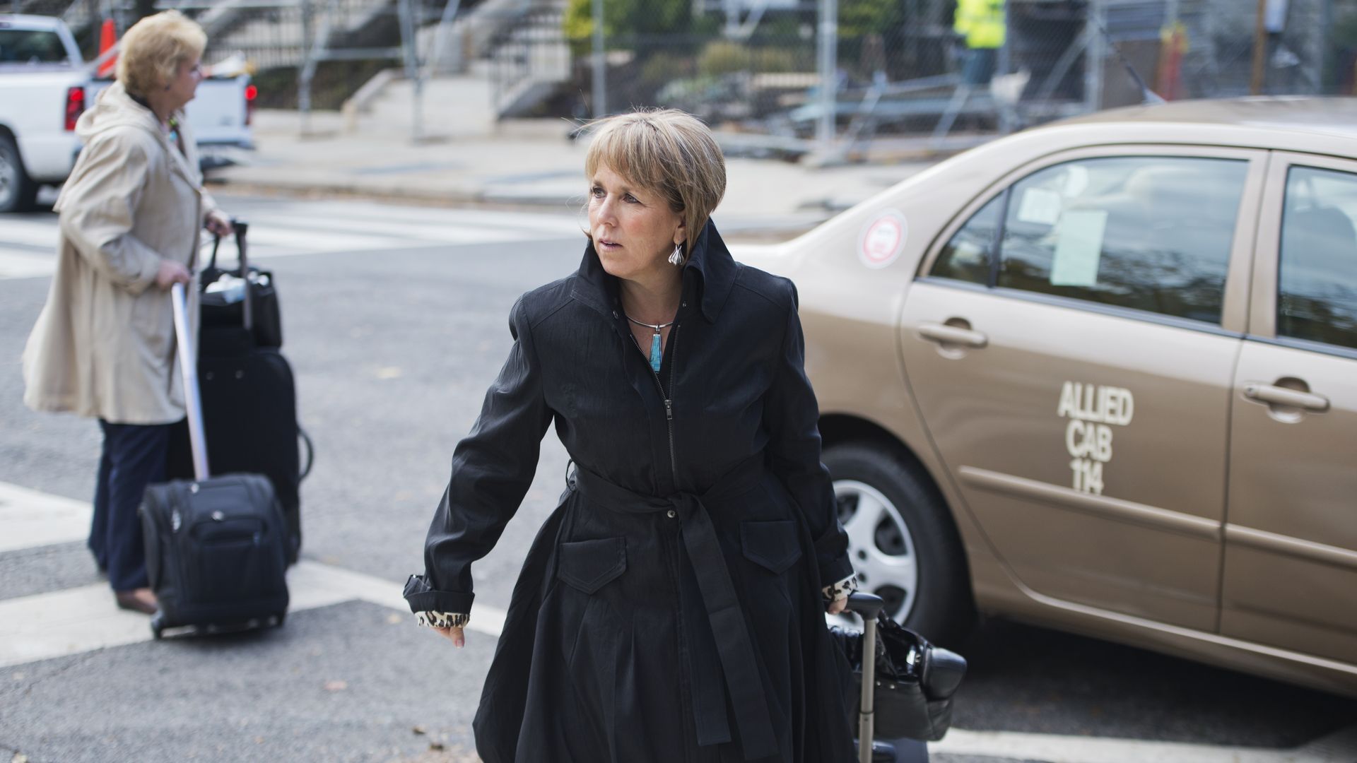 New Mexico Governor Michelle Lujan Grisham totes a suitcase as she arrives on Capitol Hill.
