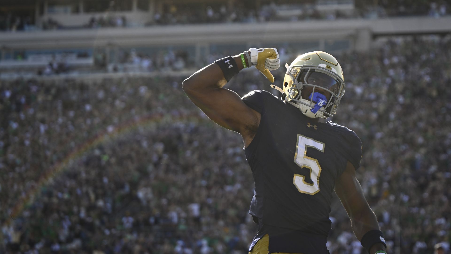 A football player in front of a crowd