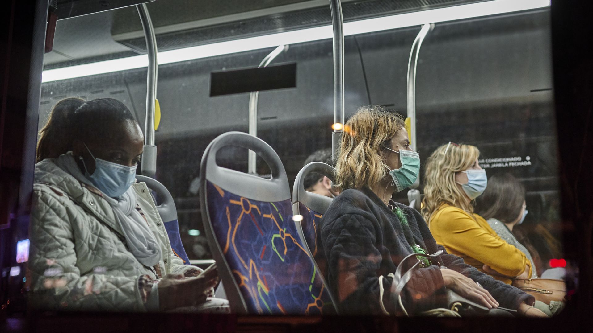 Passengers wear mandatory protective masks while riding on a bus in Avenida da Liberdade during the COVID-19 Coronavirus pandemic on November 19, 2020 in Lisbon, Portugal. 