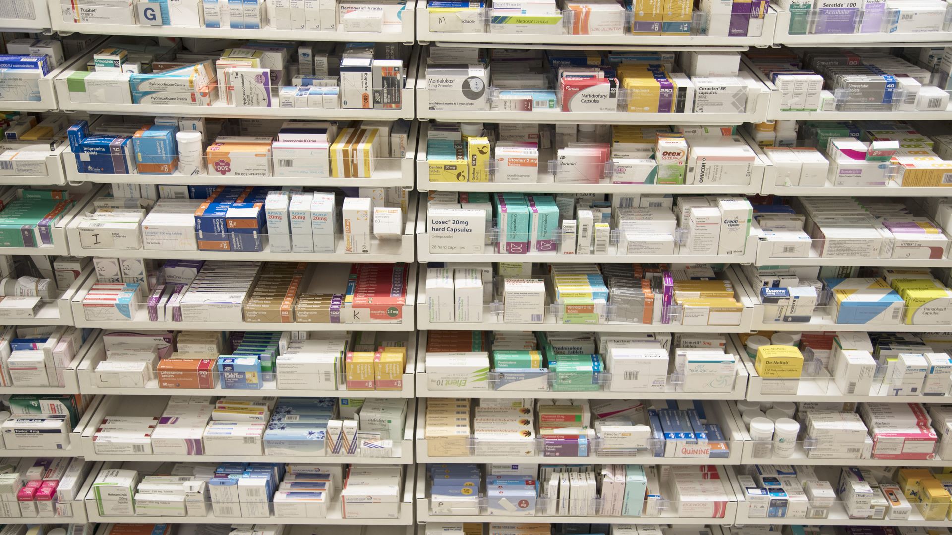 Prescription drugs behind a pharmacy counter.
