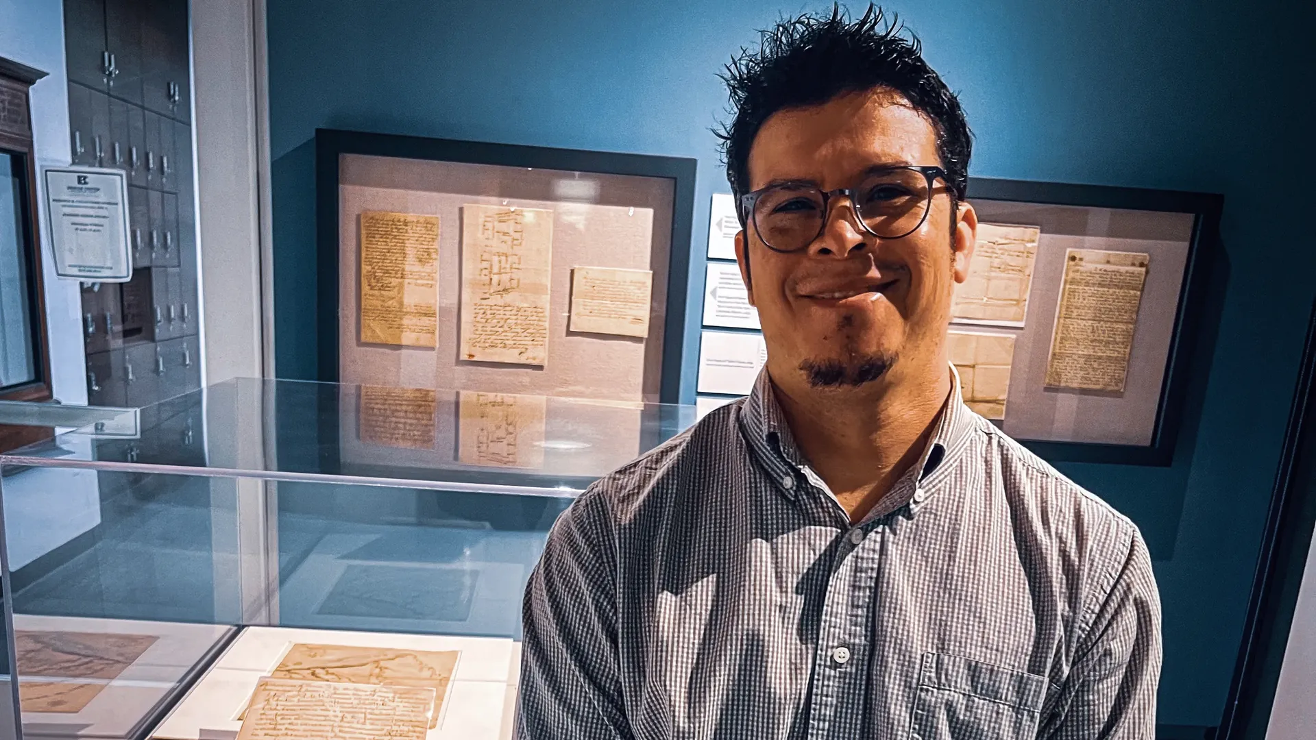 Omar "O.J." Treviño, a descendant of Webber, stands in front of her freedom documents at the Briscoe Center for American History in Austin, Texas. 